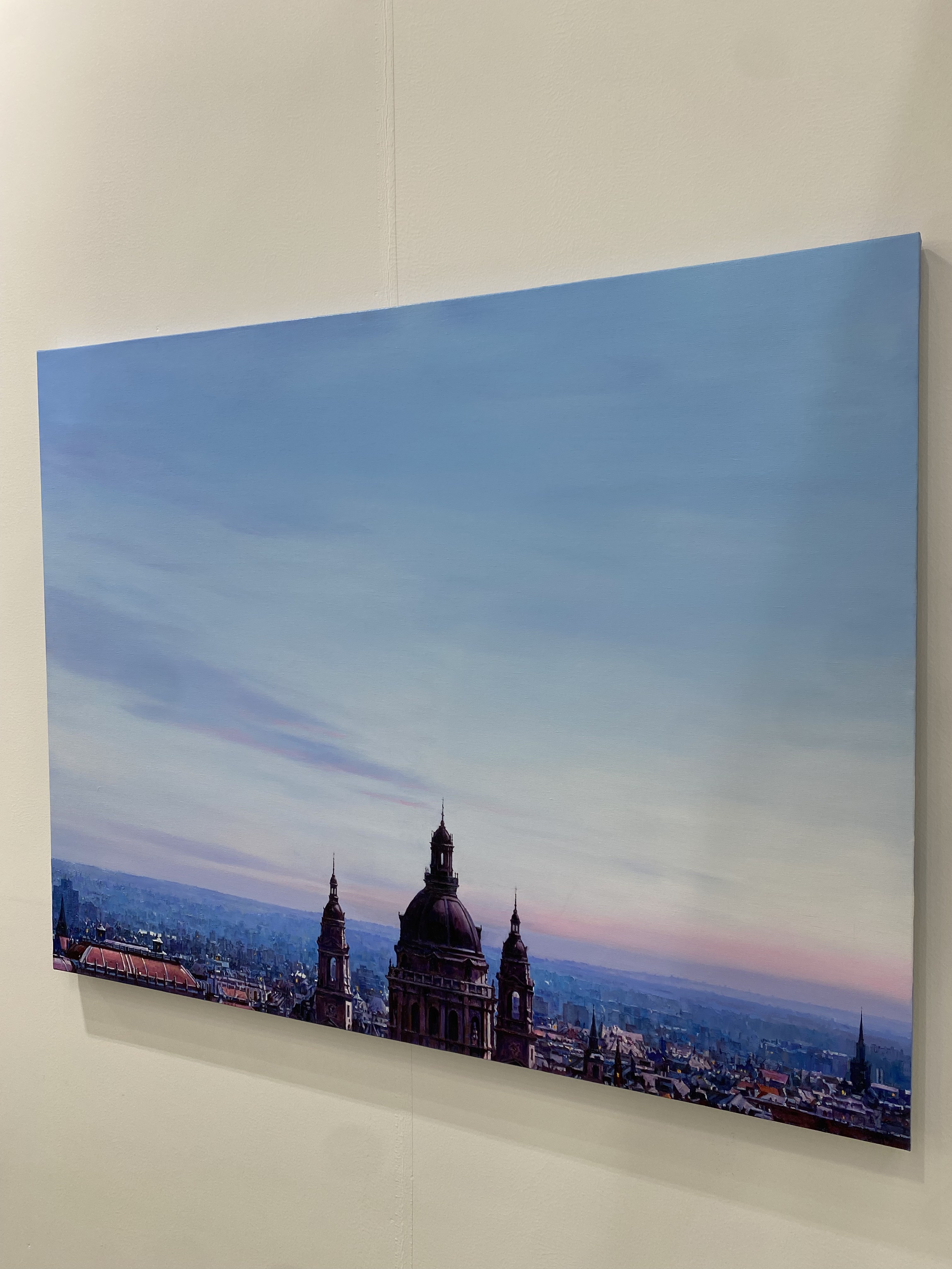 A view of a city with a clock tower in the middle of it.