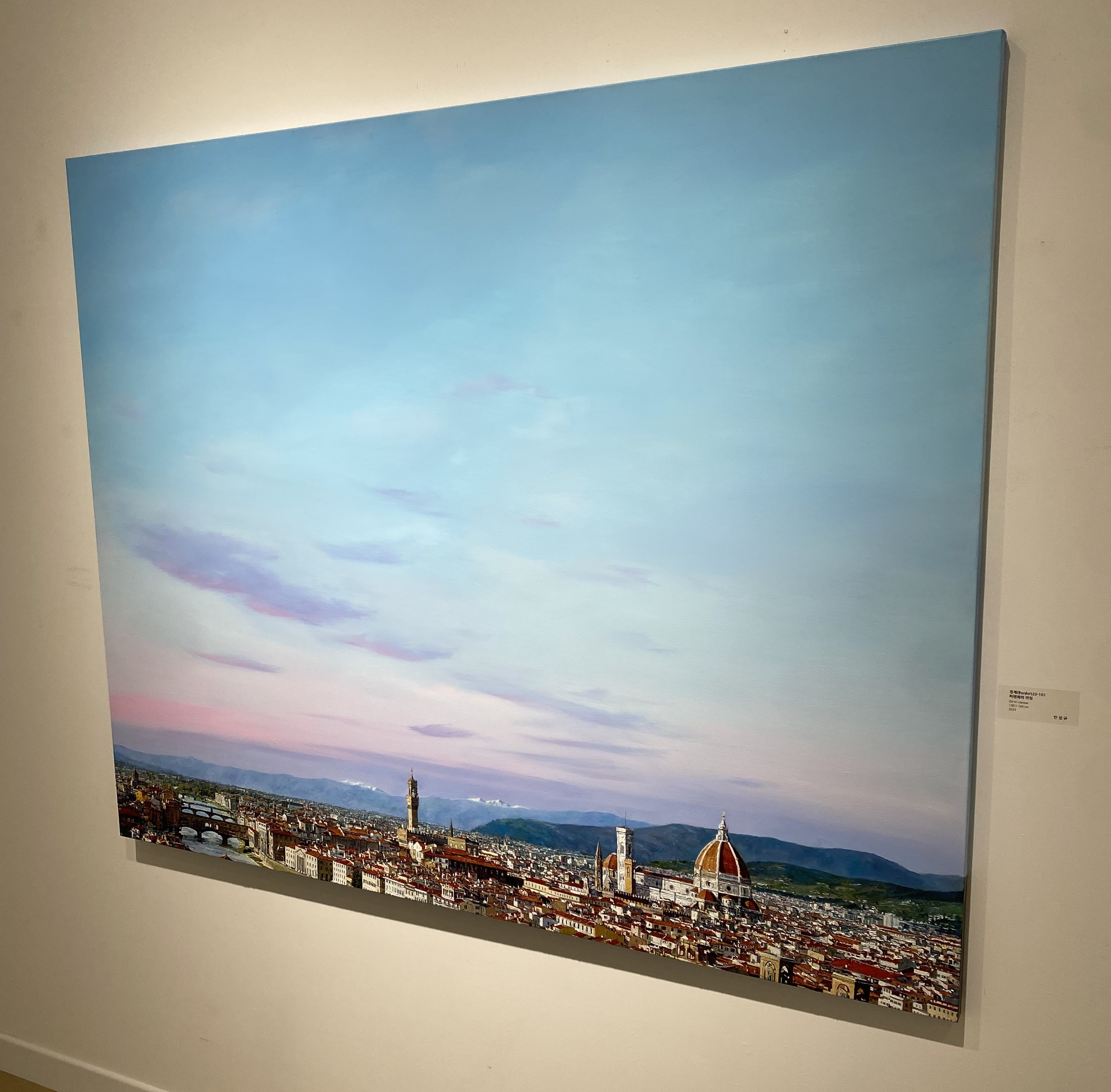 A painting hanging on a wall in a room.