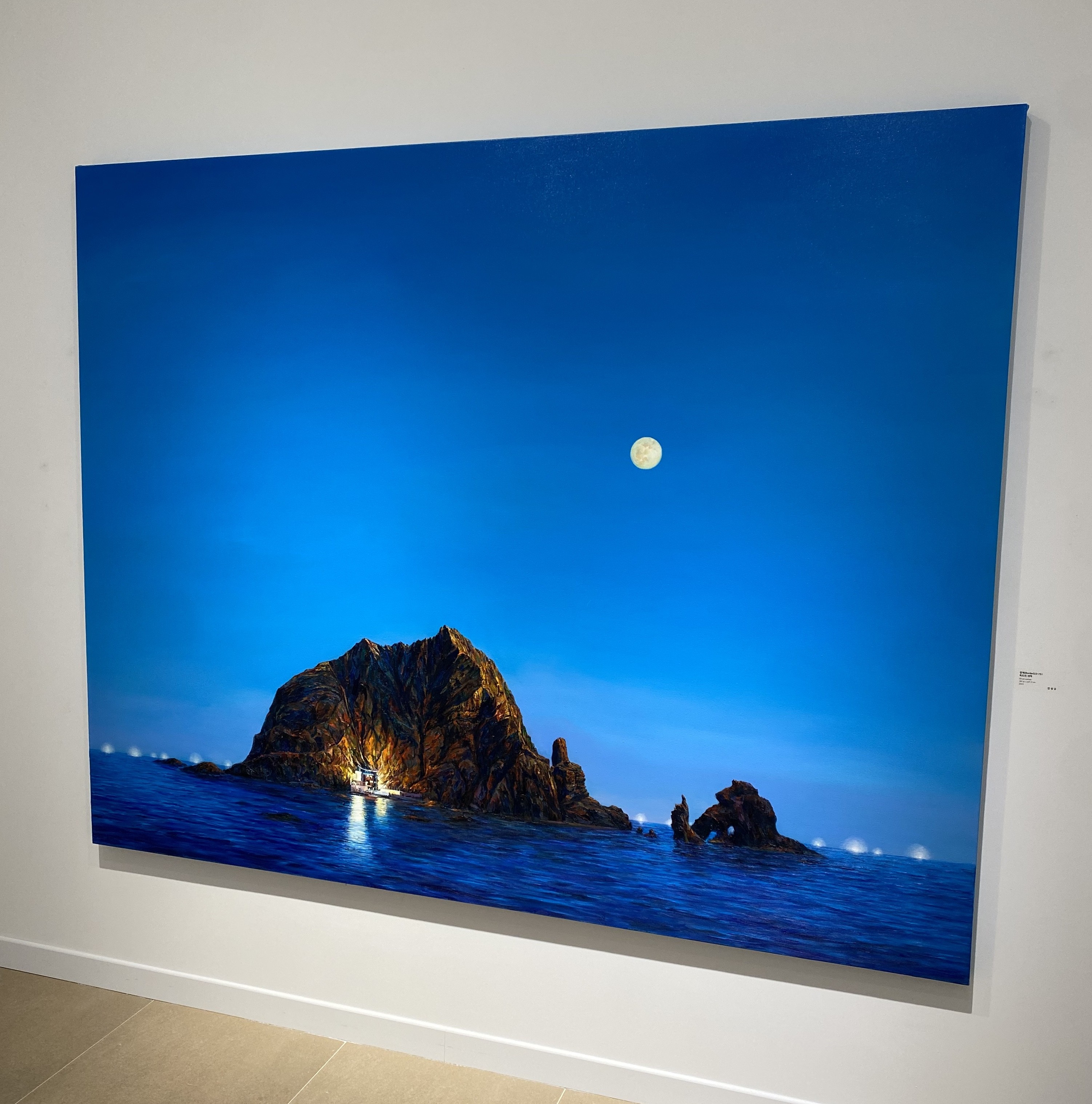A large picture hanging on a wall in a room.