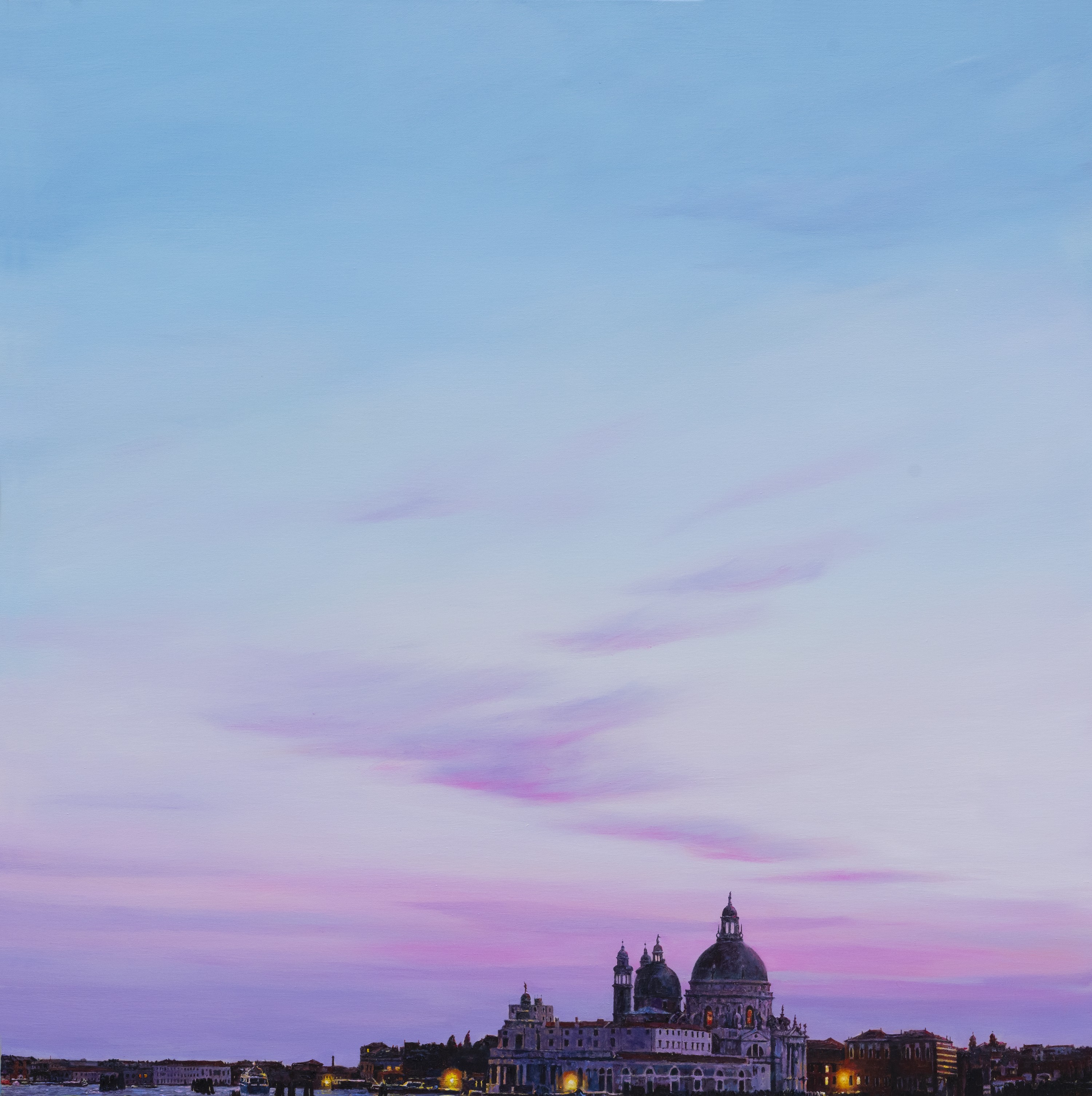 A view of a city skyline at dusk with a church in the background.