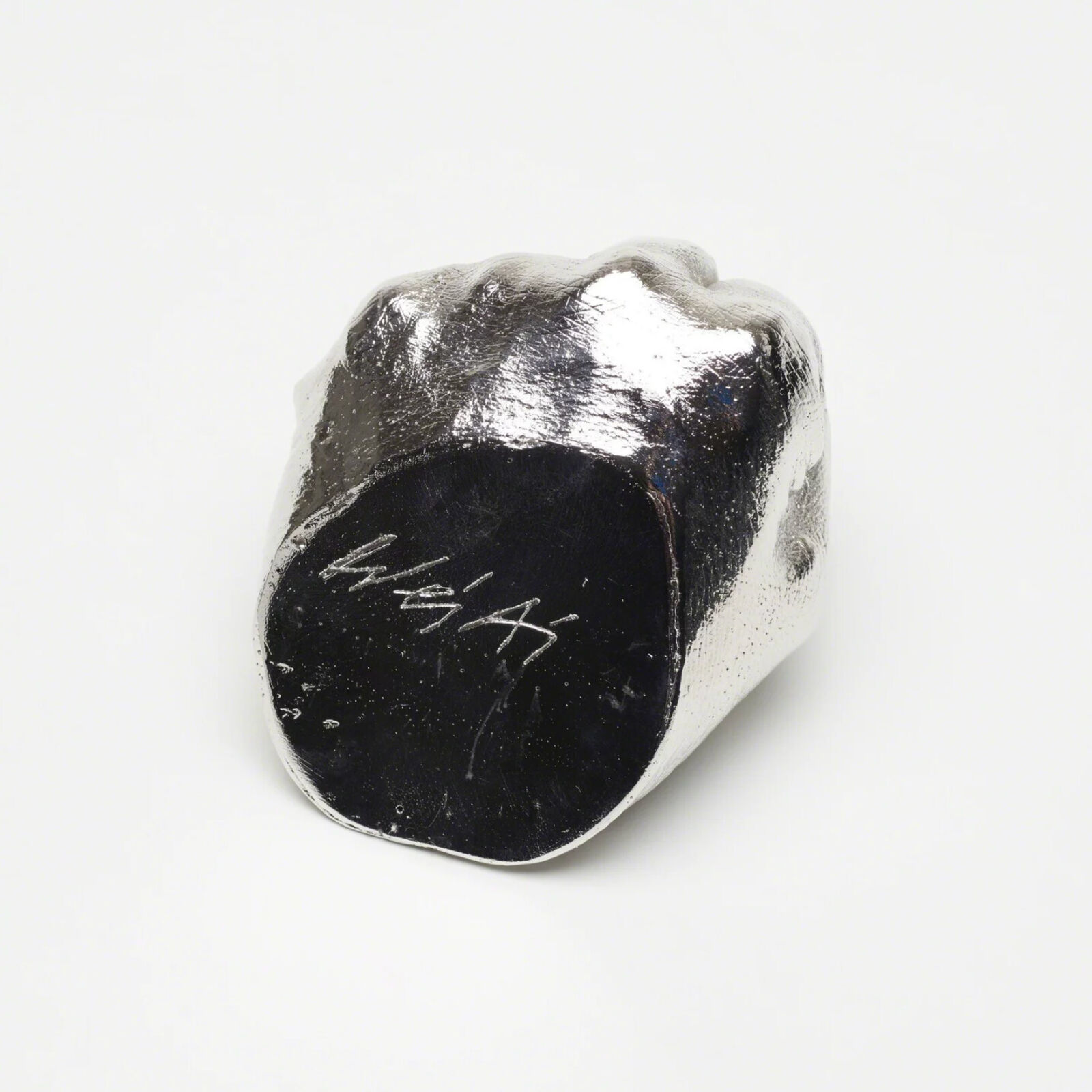 A silver hand with a finger pointing up on a white background.