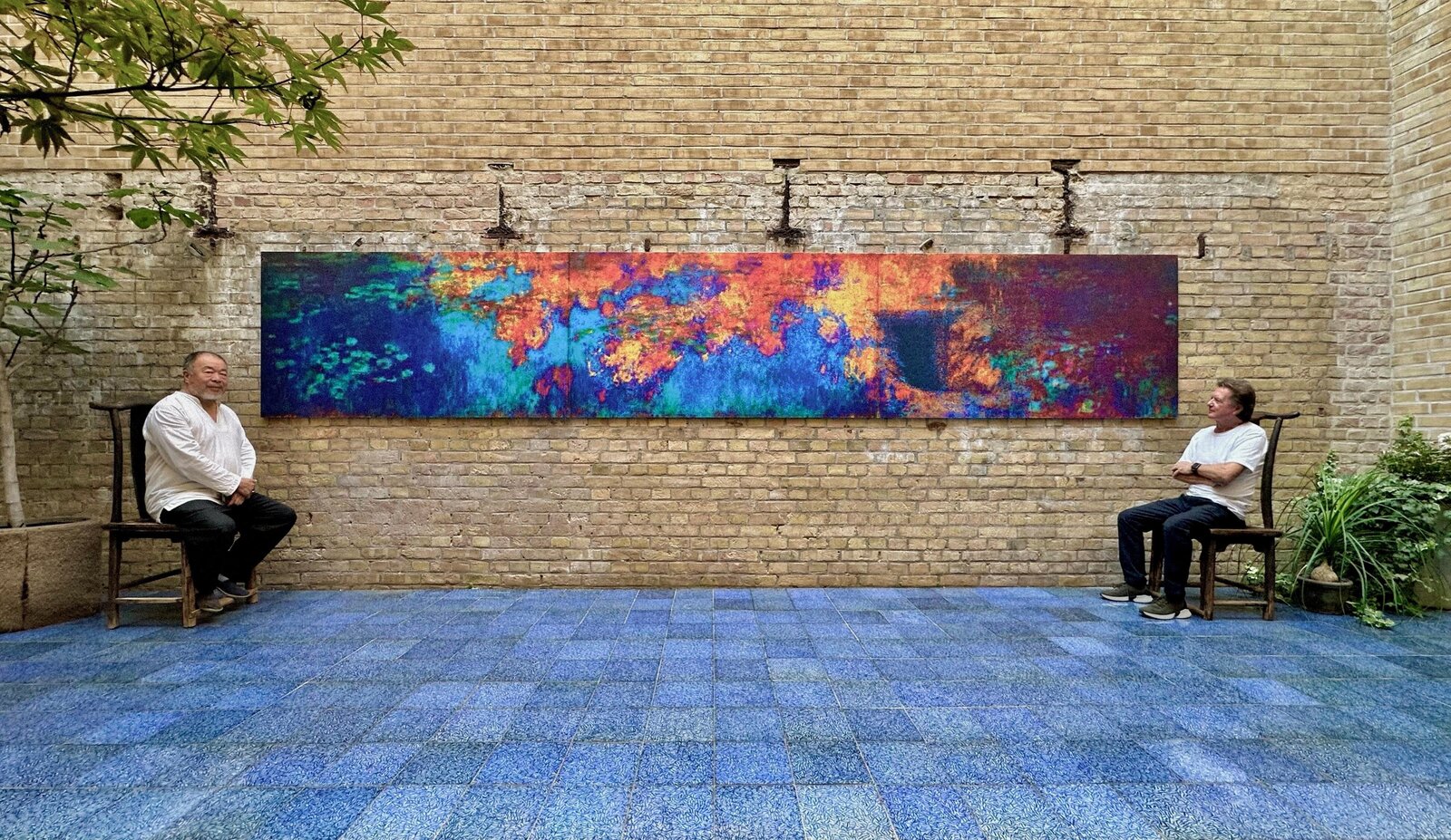 A panoramic abstract landscape blending fiery reds and oranges with deep blues.