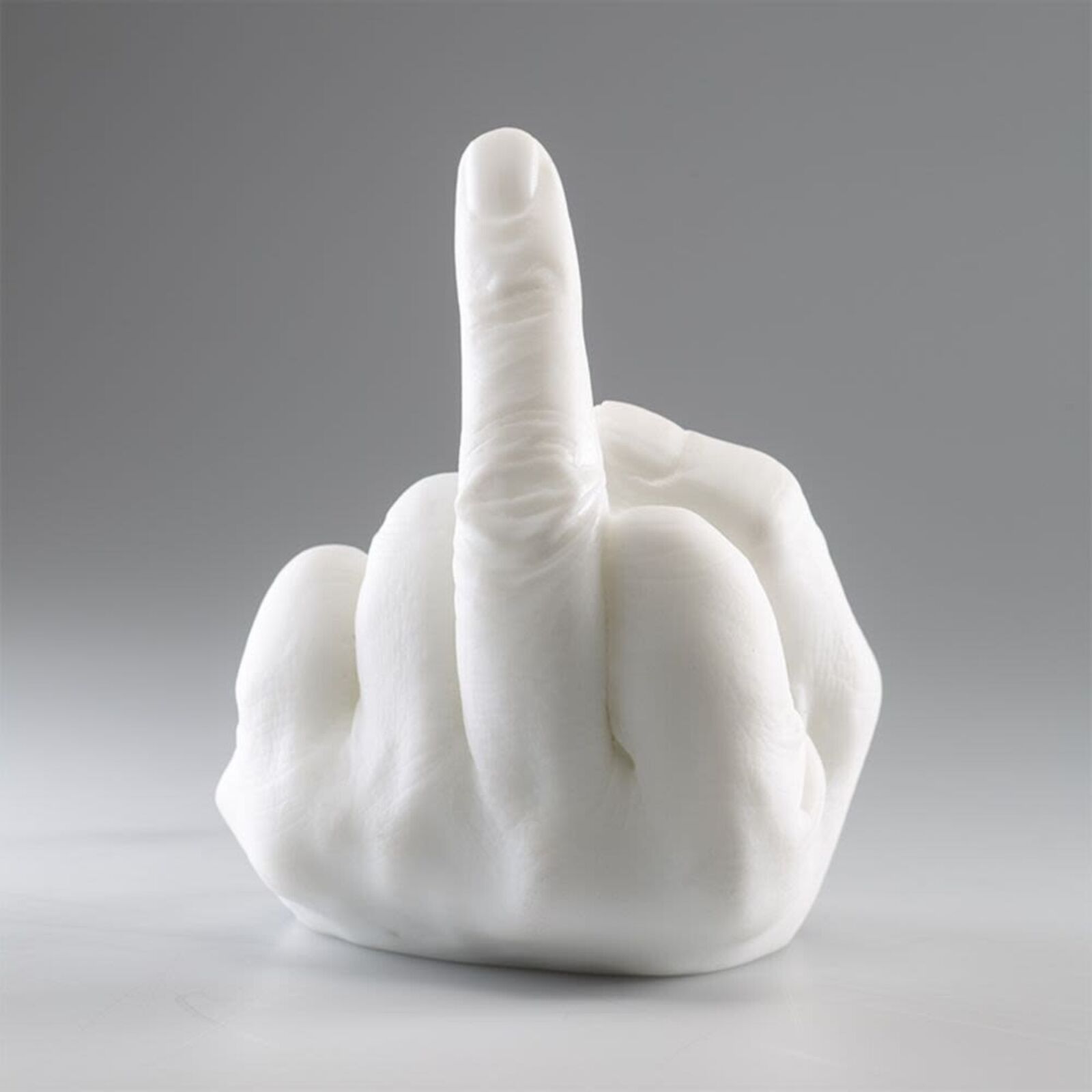 A white sculpture of a hand making a peace sign.