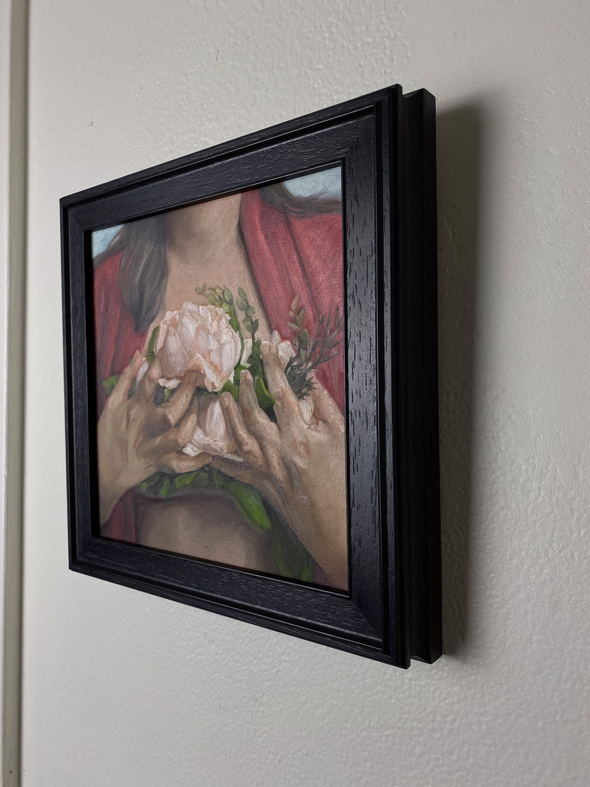 A painting of a woman holding a flower in her hands.