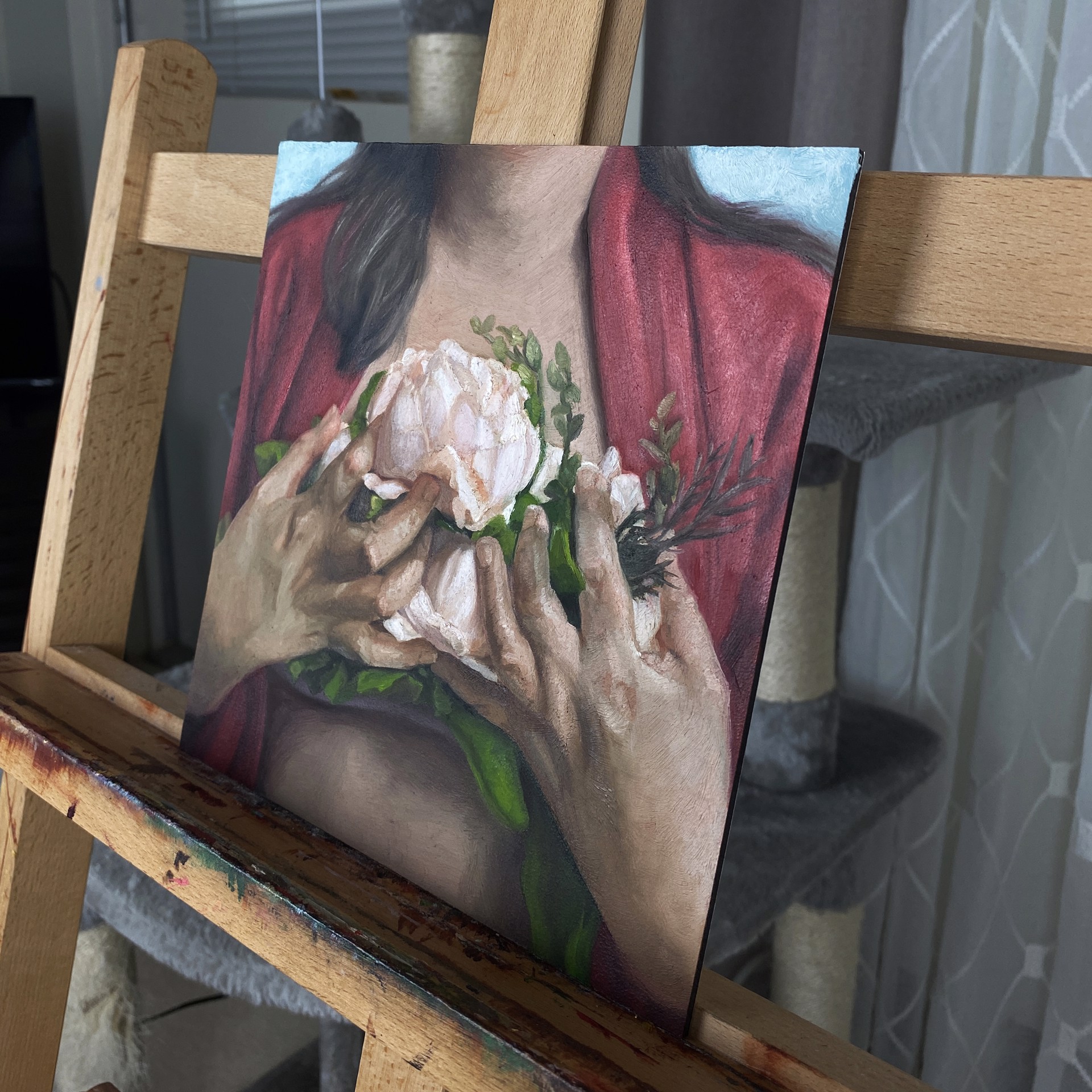 A painting of a woman holding a flower in her hands.