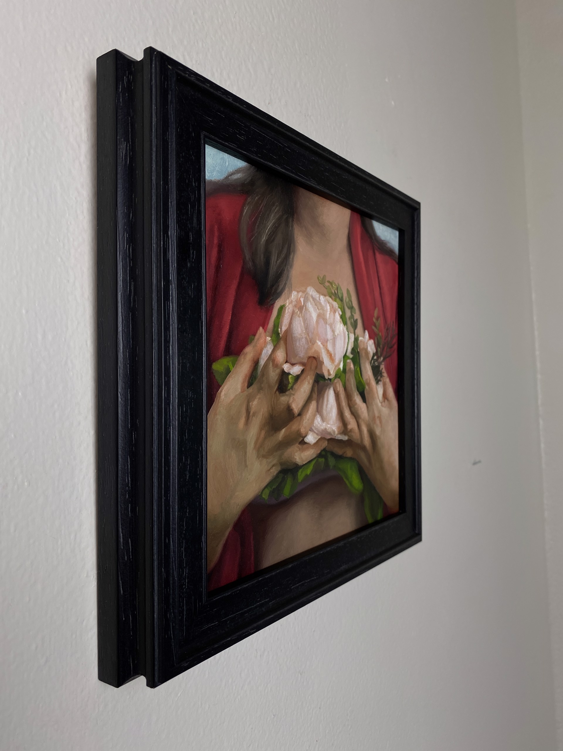 A painting of a woman holding a flower in her hands.