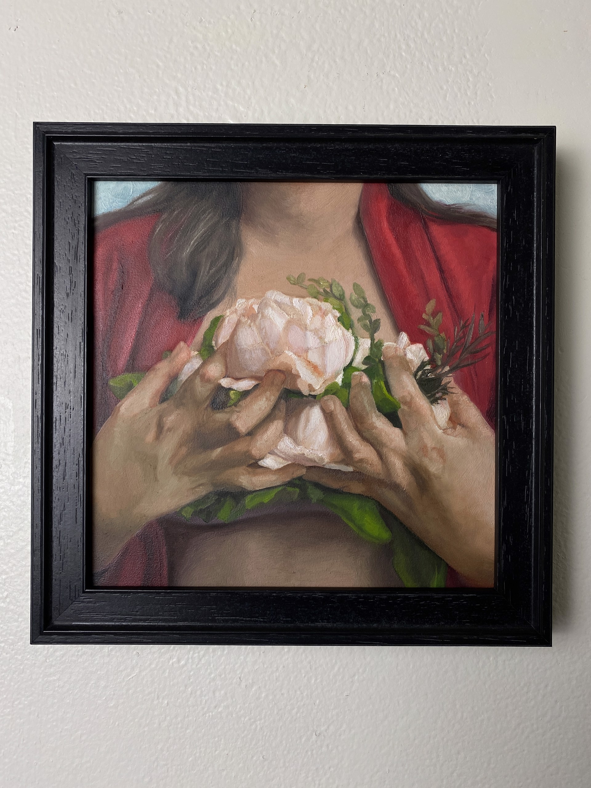 A painting of a woman holding a flower in her hands.
