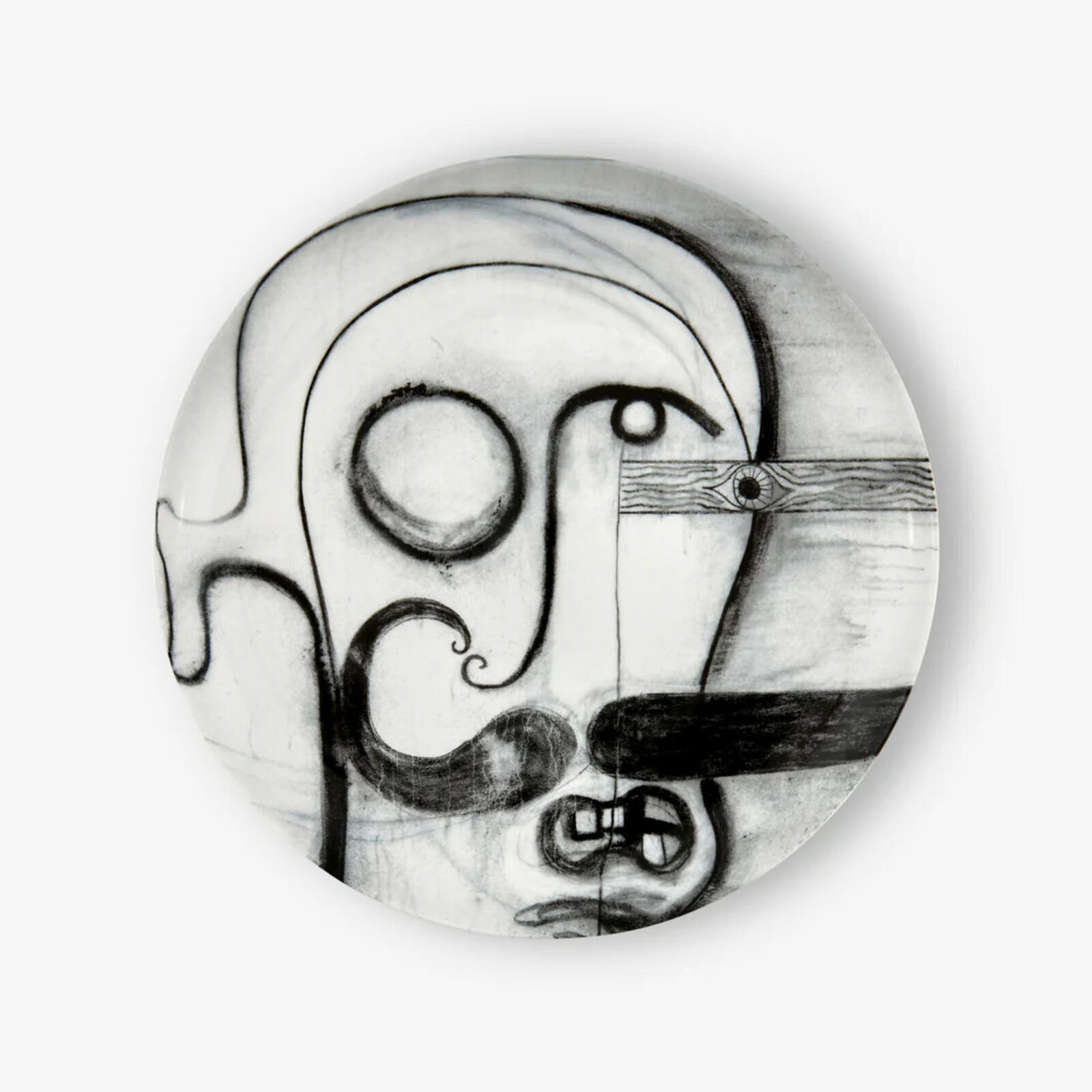 A black and white drawing of a man's face on a plate.