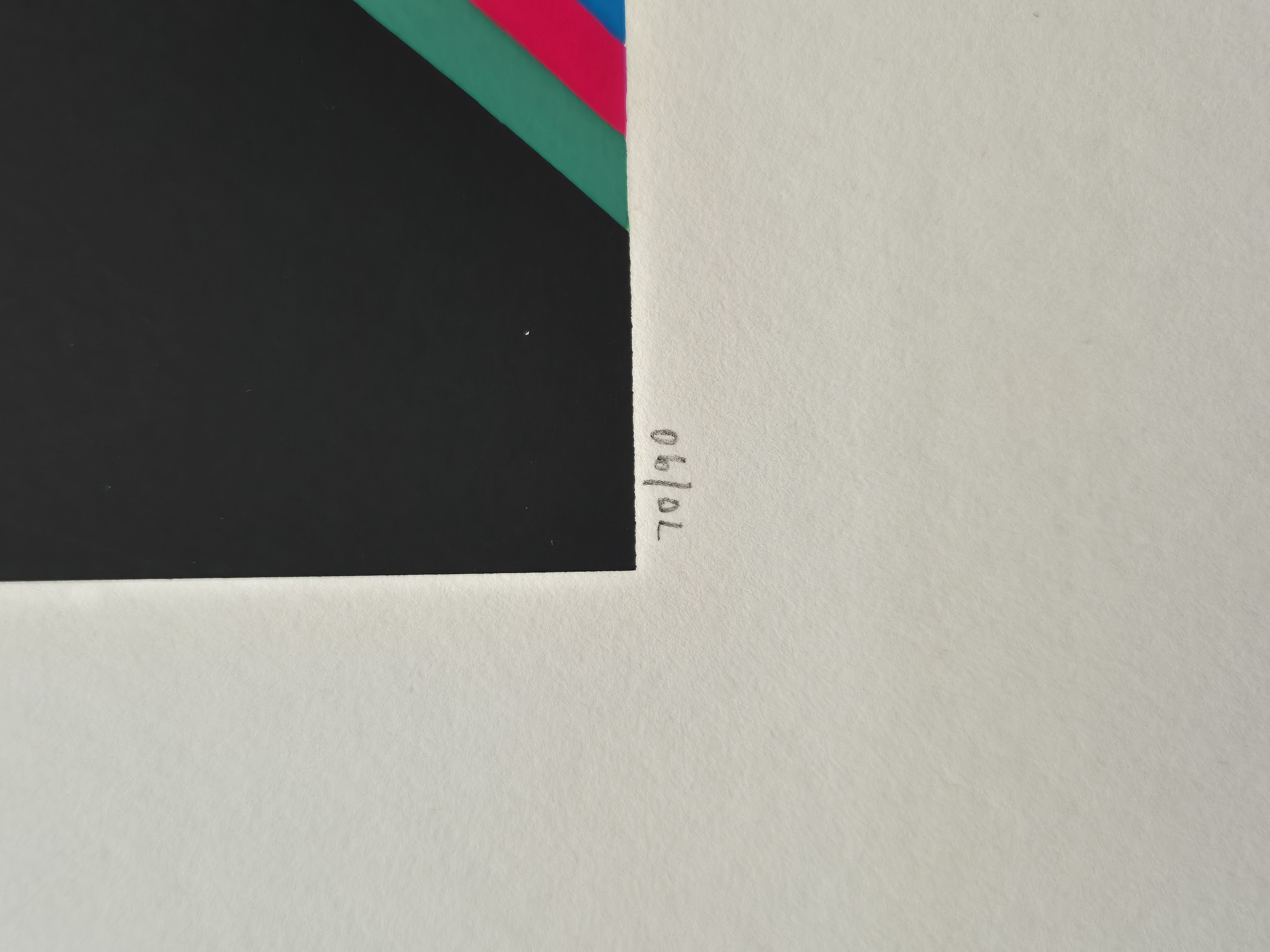 A graphic print featuring a black rectangle with a vibrant, wavy rainbow pattern against a red background.