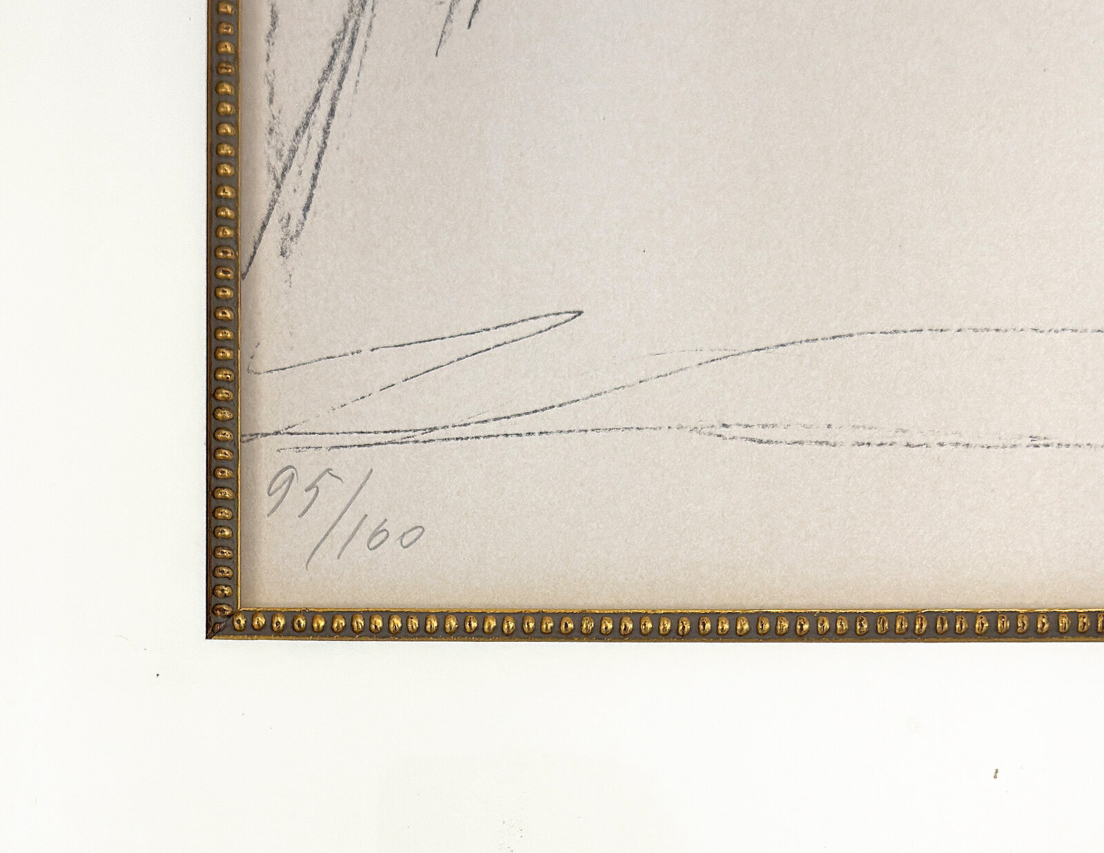 A graphite sketch of a seated nude figure in a studio setting.