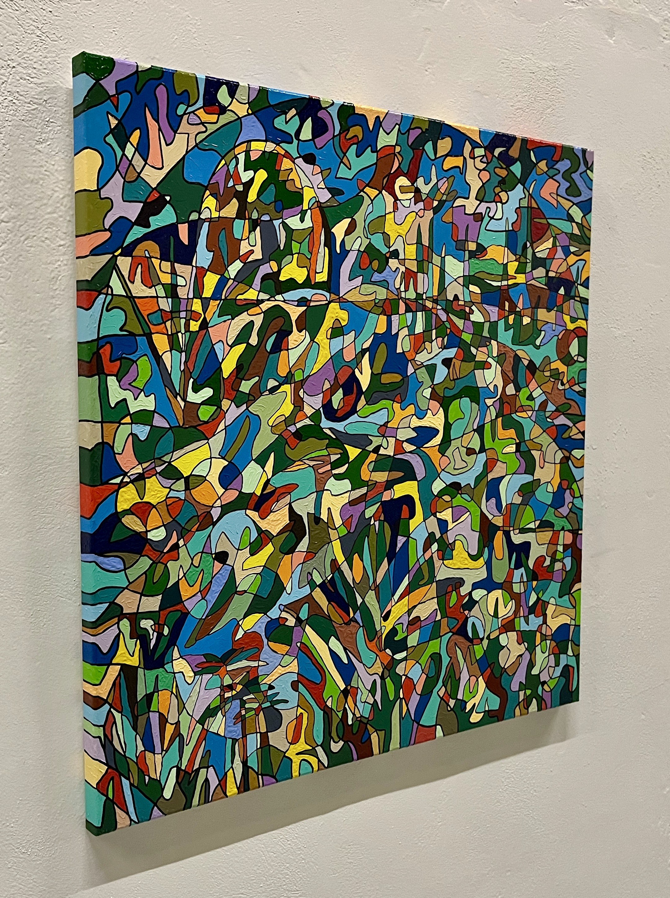 A colorful painting on a wall in a room.