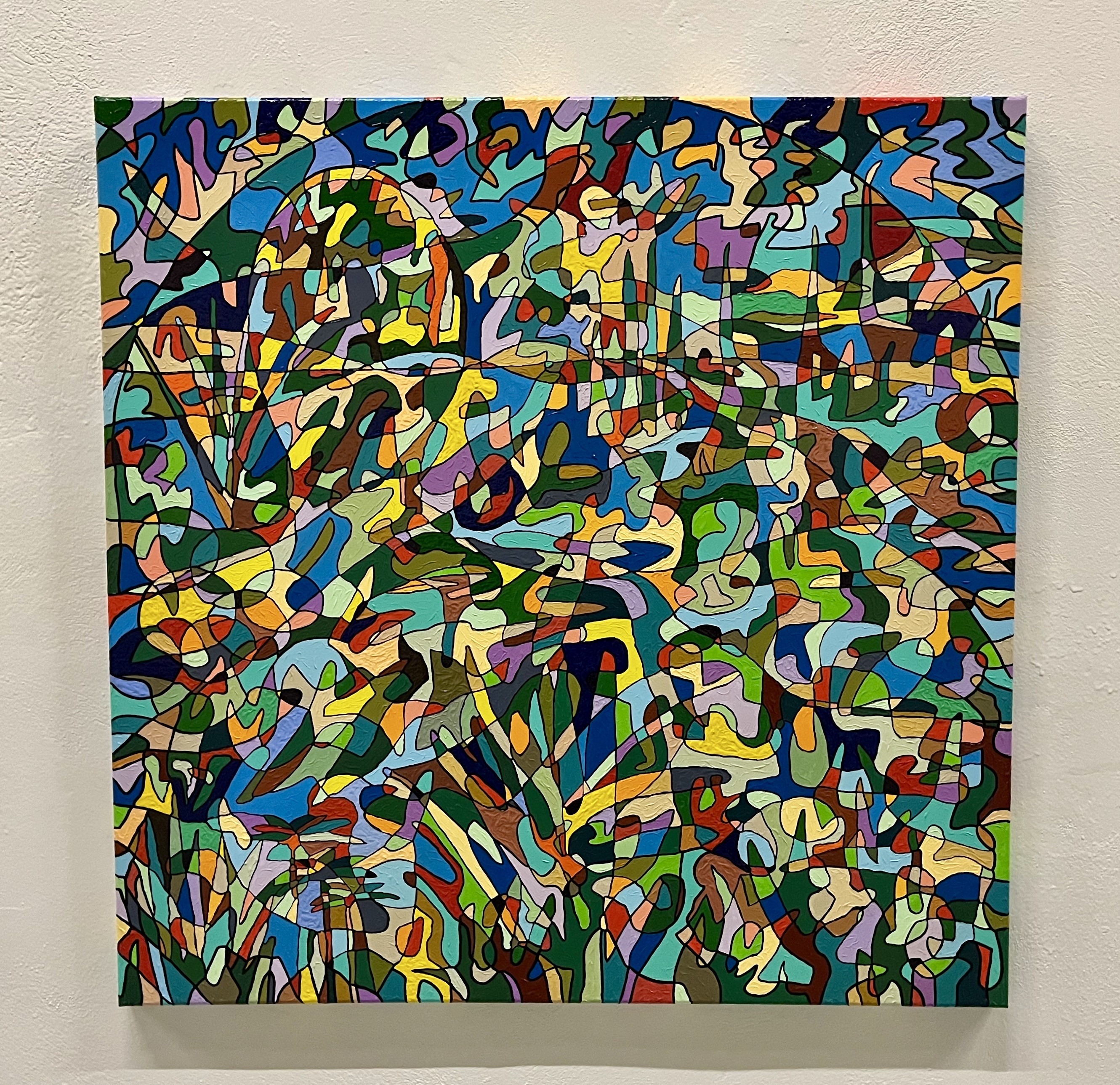 A colorful painting on a wall in a room.