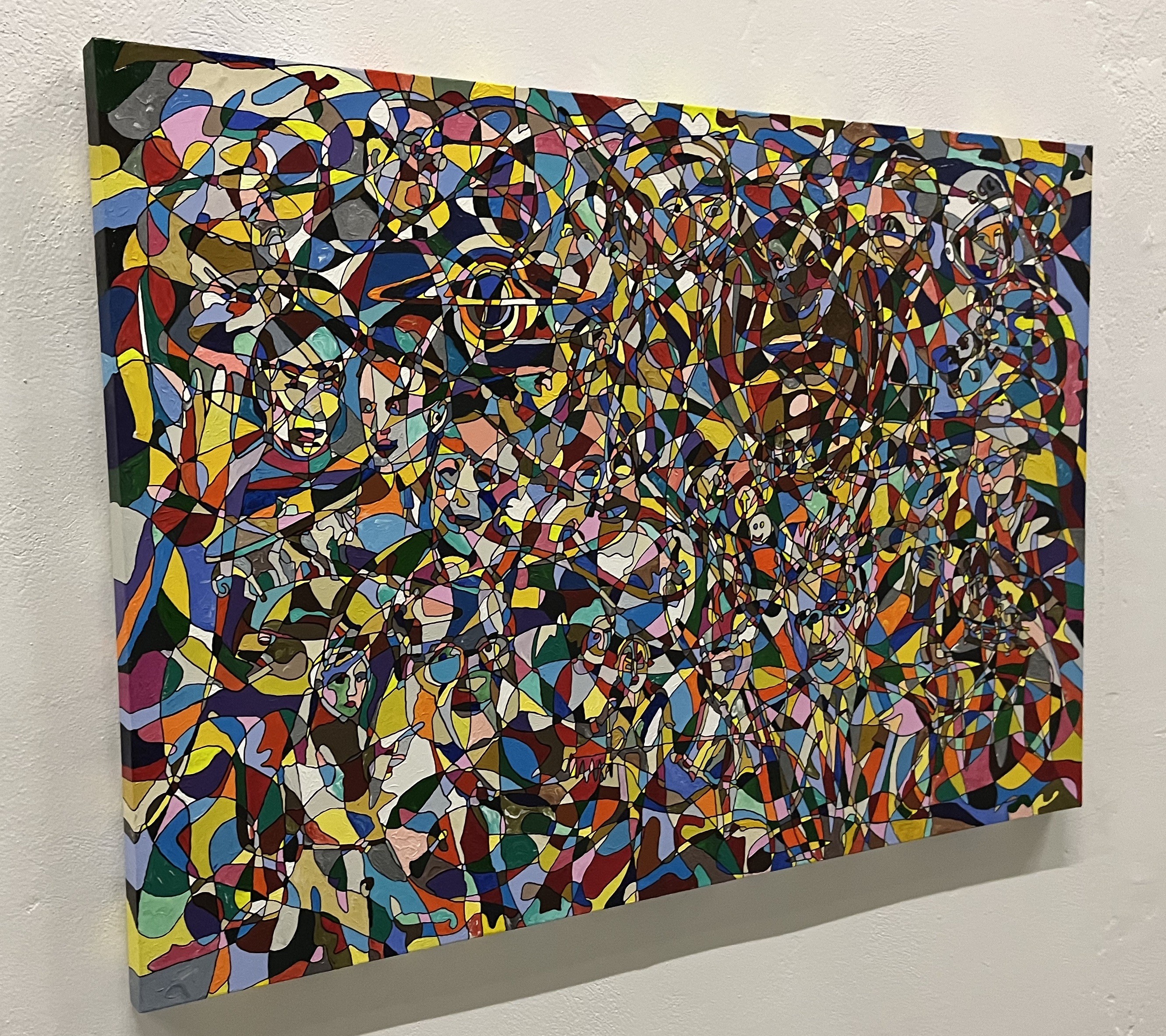 A painting on a wall in a room with a white wall.