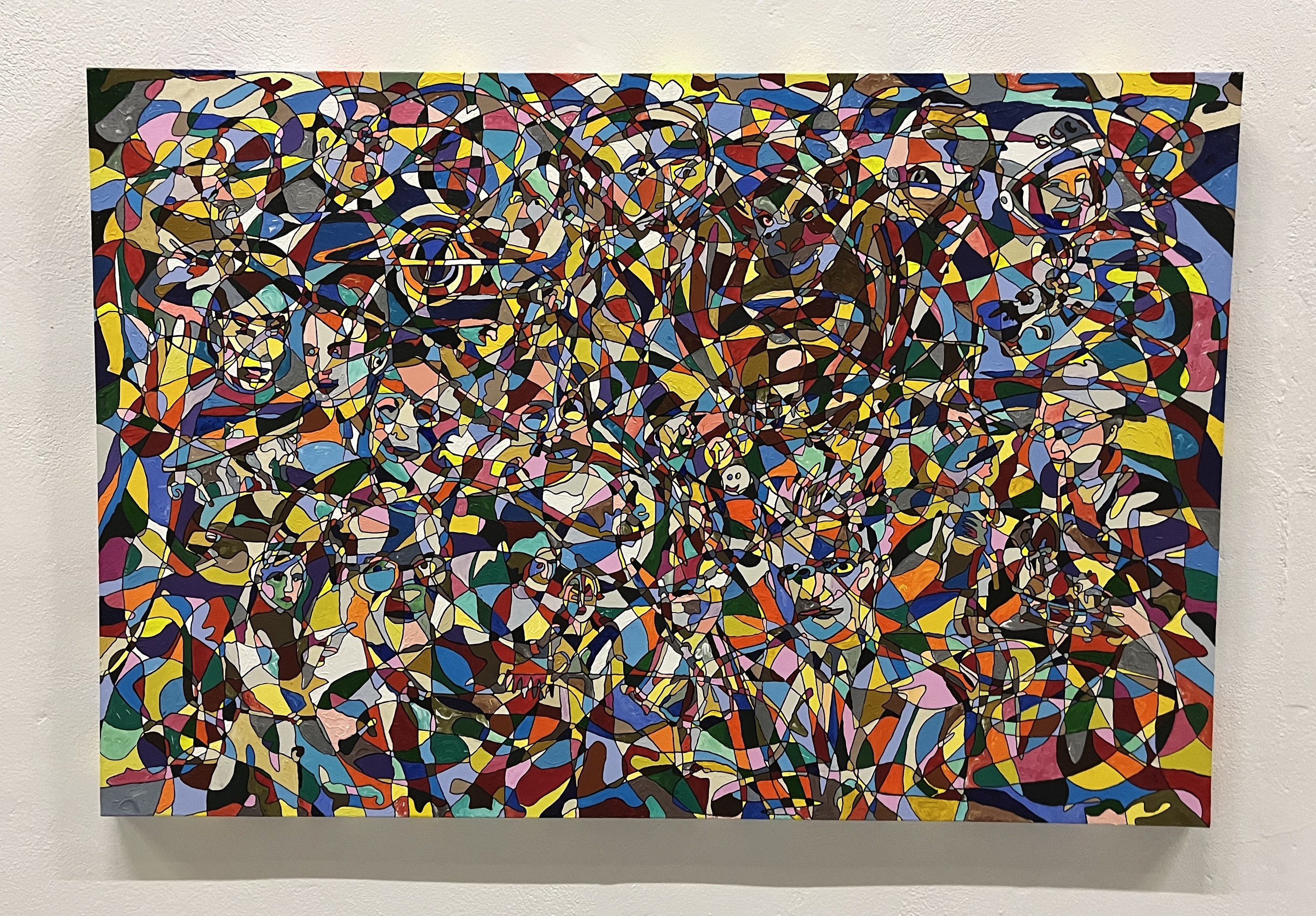 A painting on a wall in a room with a white wall.