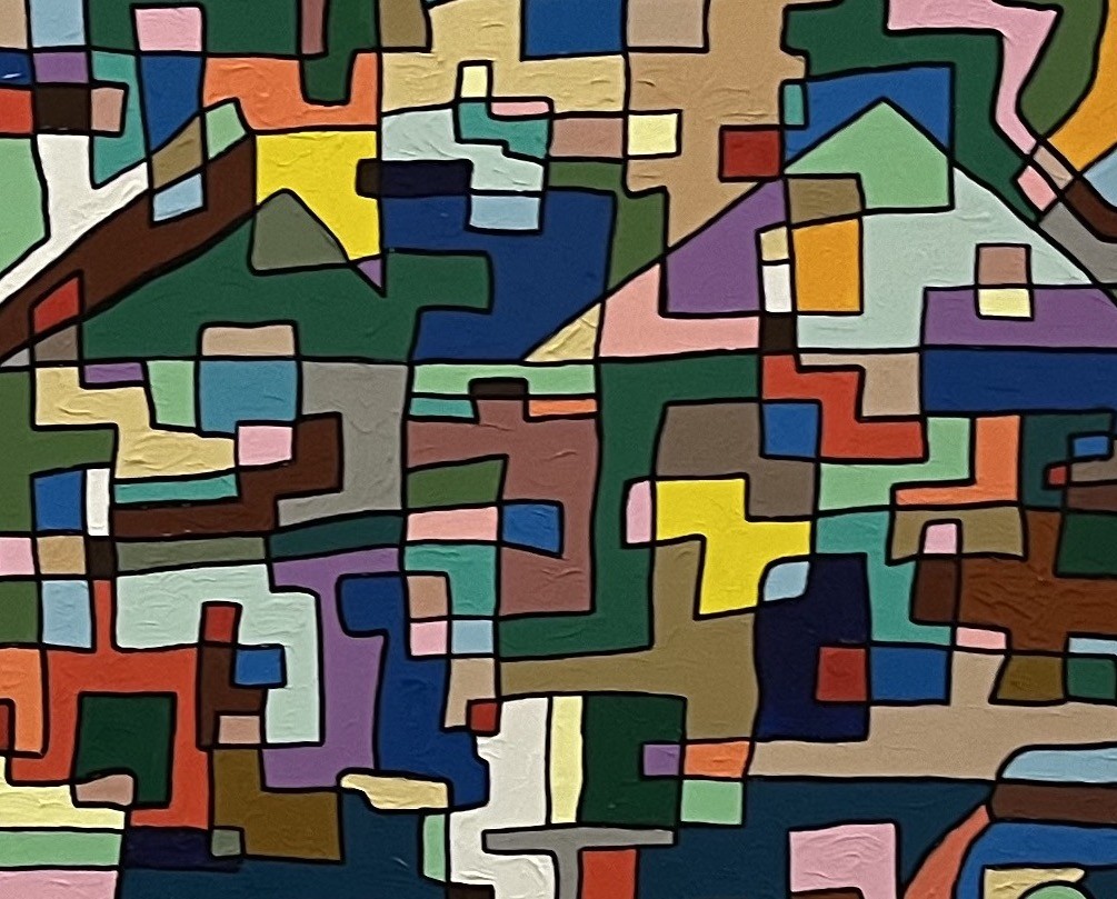 A painting on a wall in a room with a white wall.