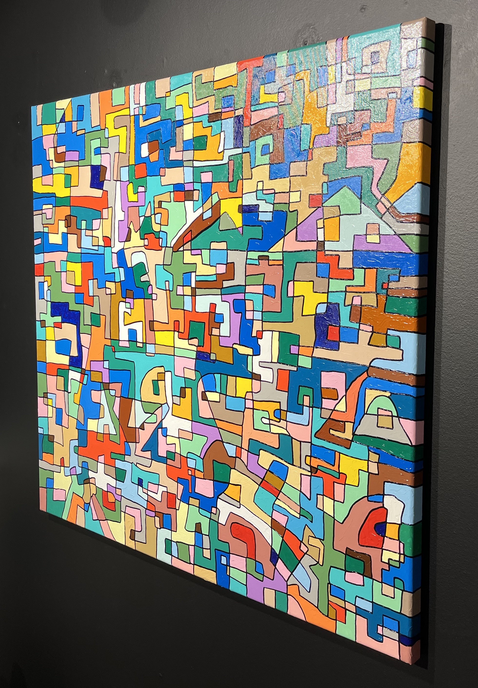 A painting on a wall in a room with a white wall.