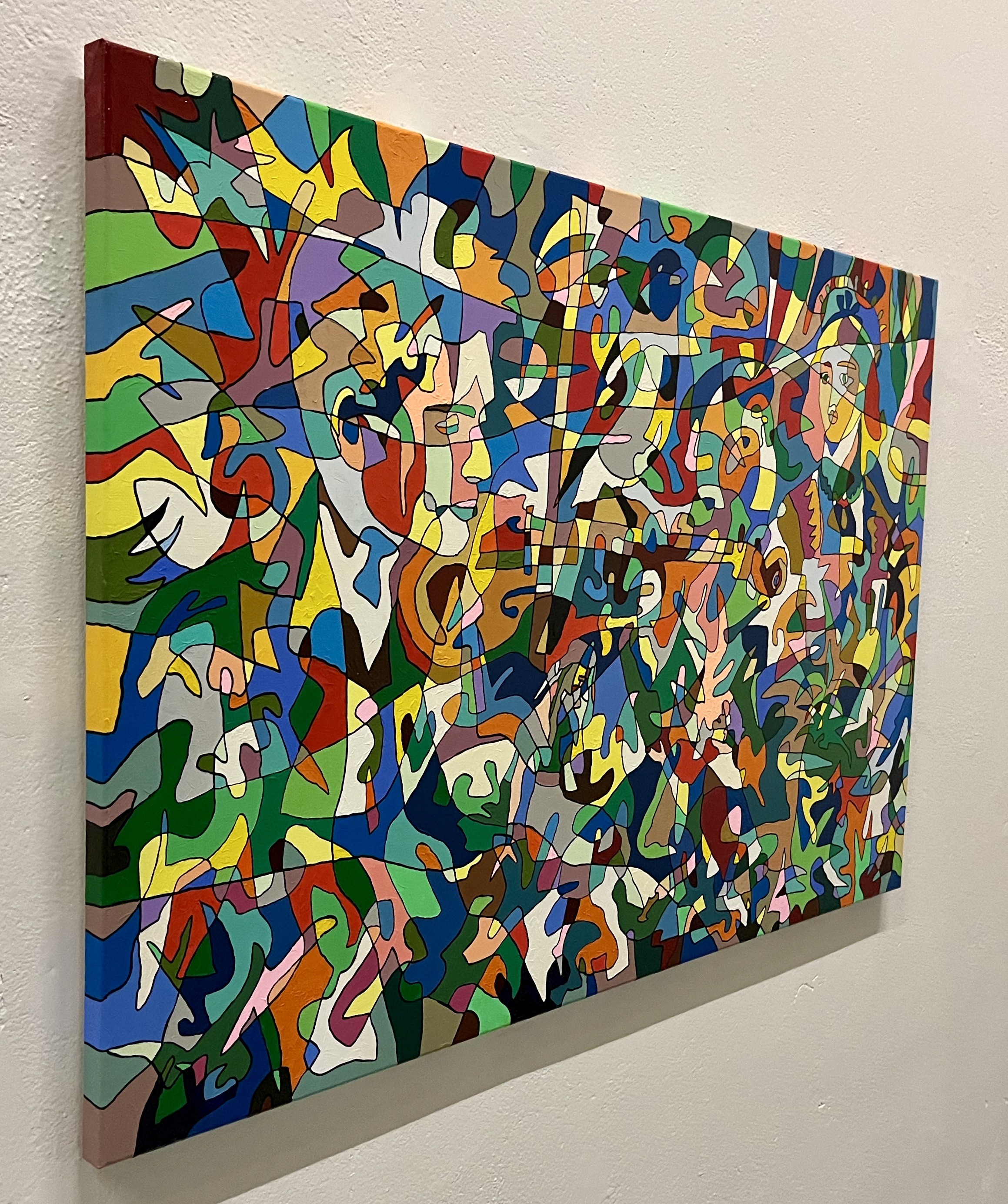 A colorful painting hanging on a wall in a room.