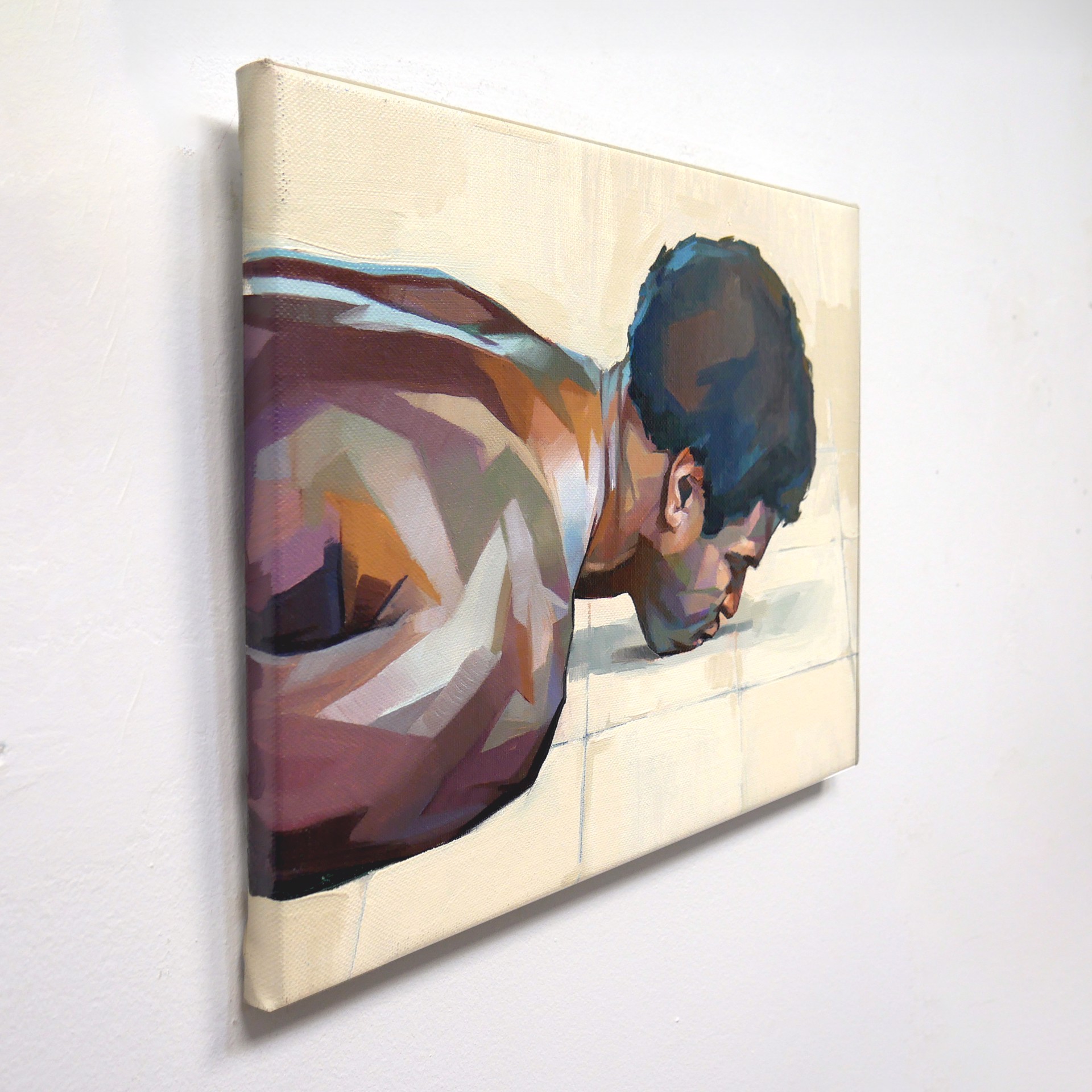A painting of a man laying on the floor.