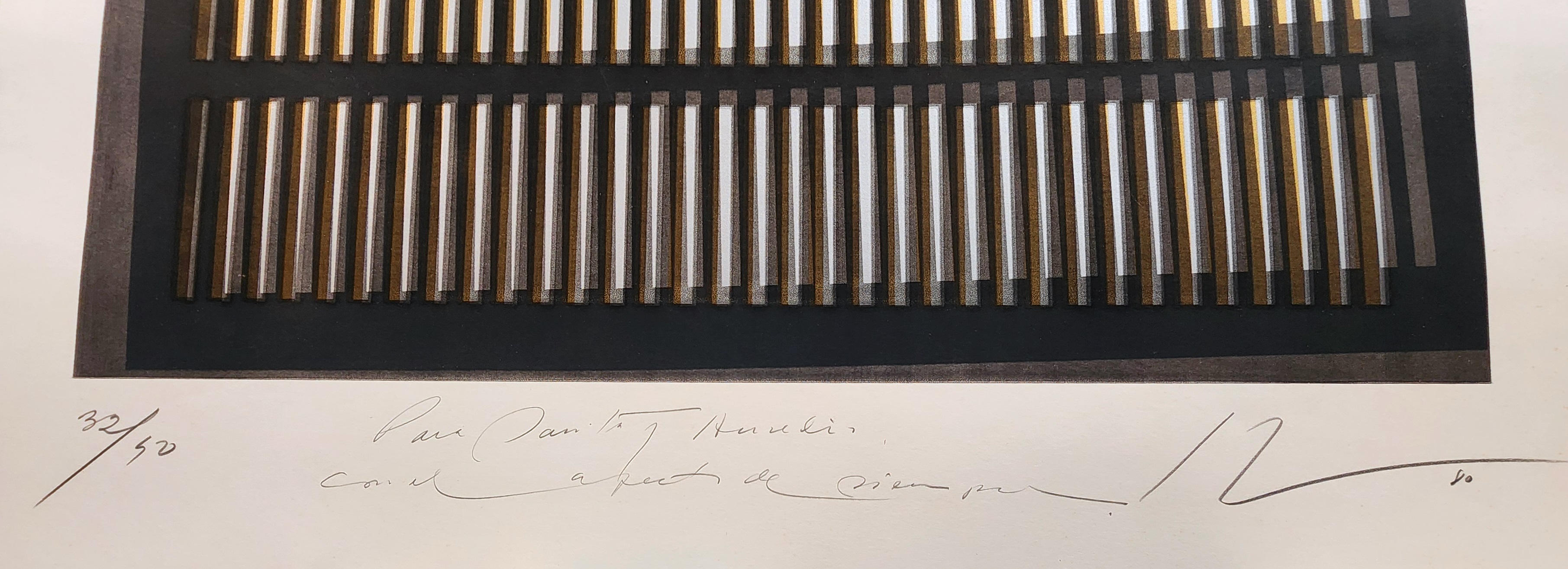 A black and gold painting on a white wall.