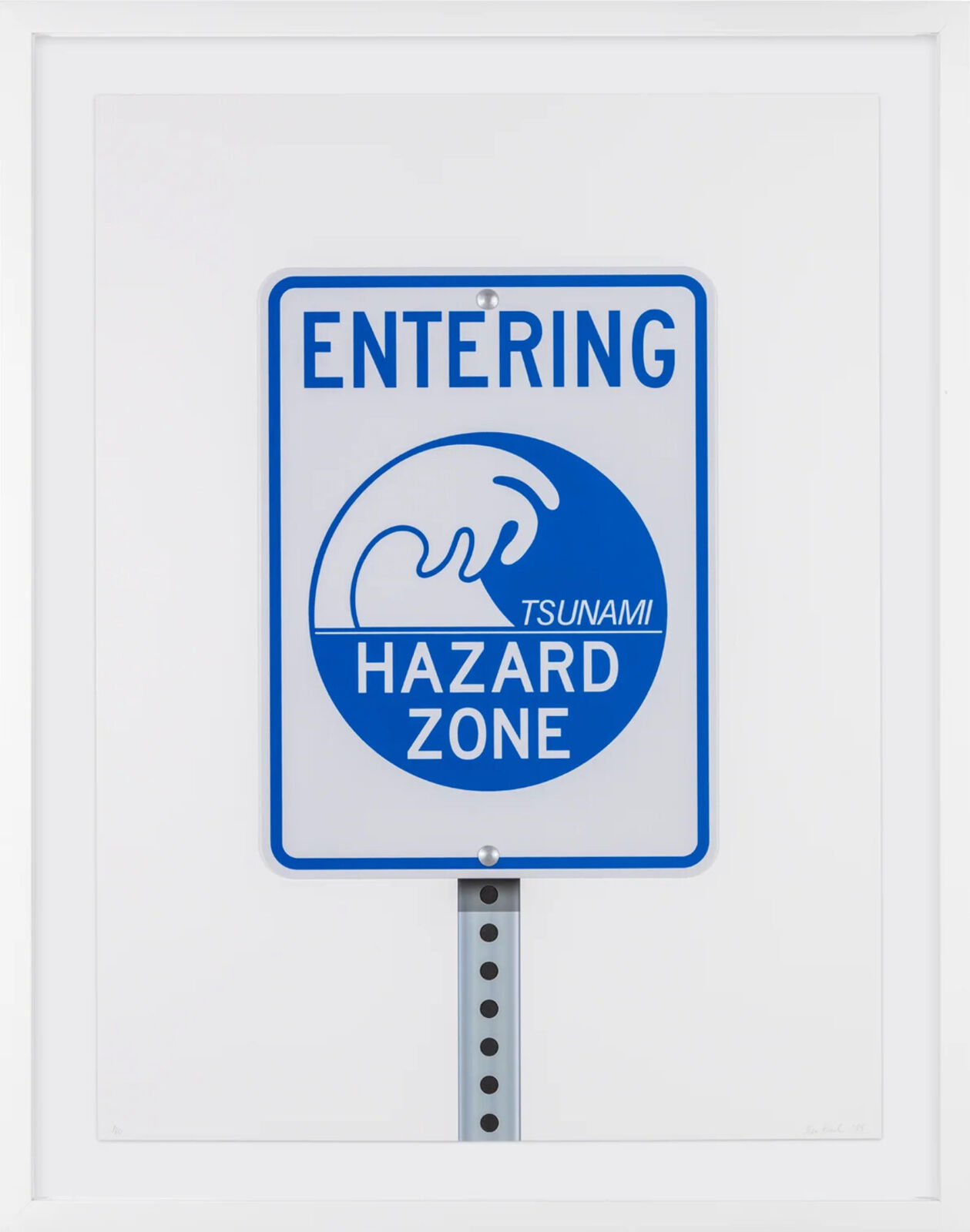 A blue and white sign that says "Entering Tsunami Hazard Zone"