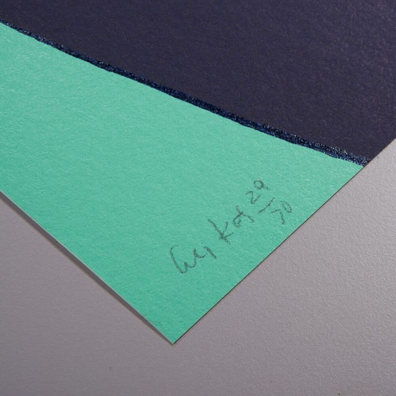 A woman standing in front of a painting on a wall.