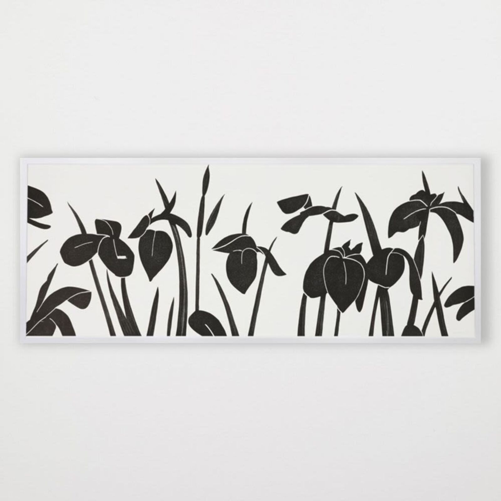 A black and white picture of a bunch of flowers on a wall.