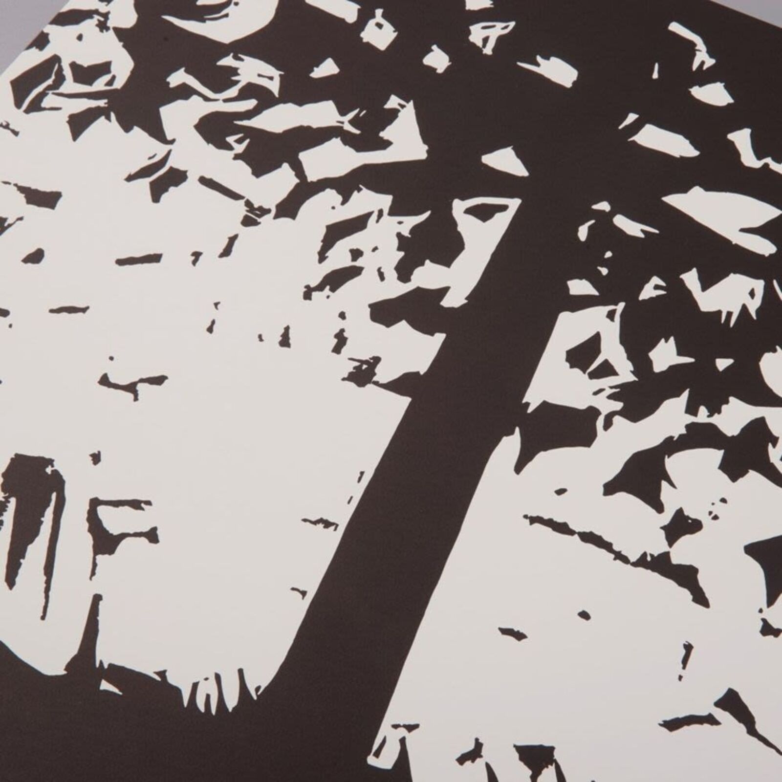 A black and white print of trees in a forest.