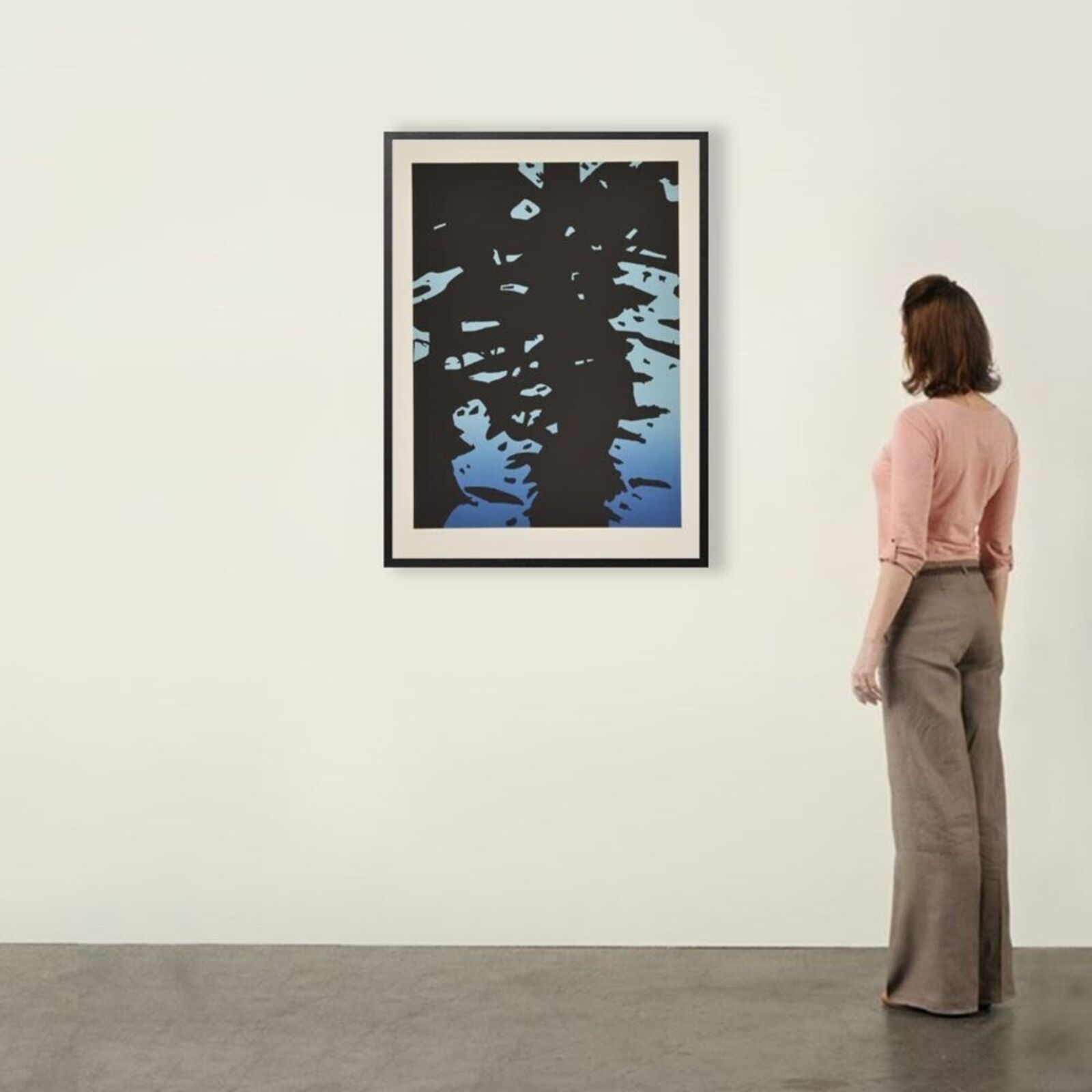 A black and blue print hanging on a wall.