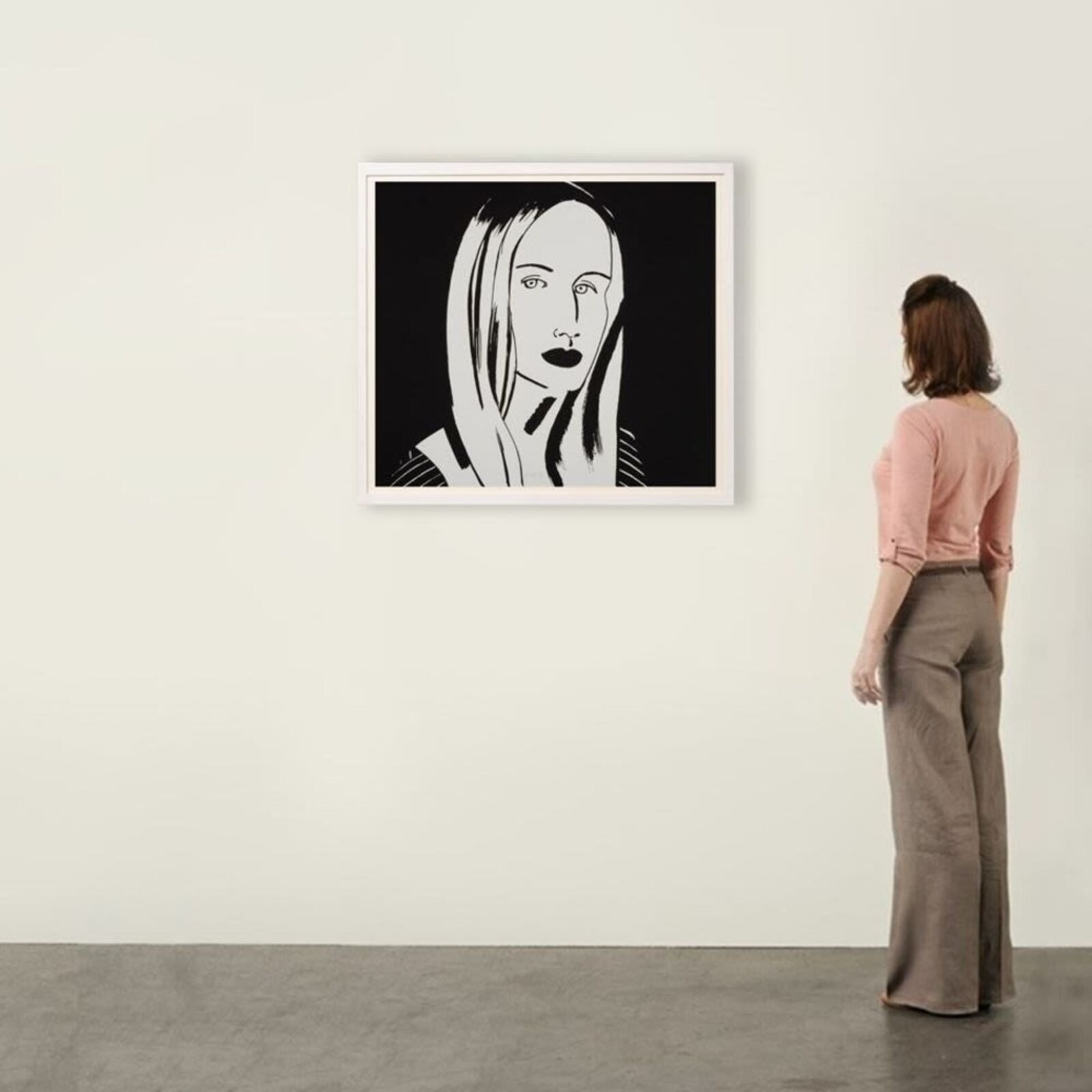 A black and white drawing of a woman's face on a wall.