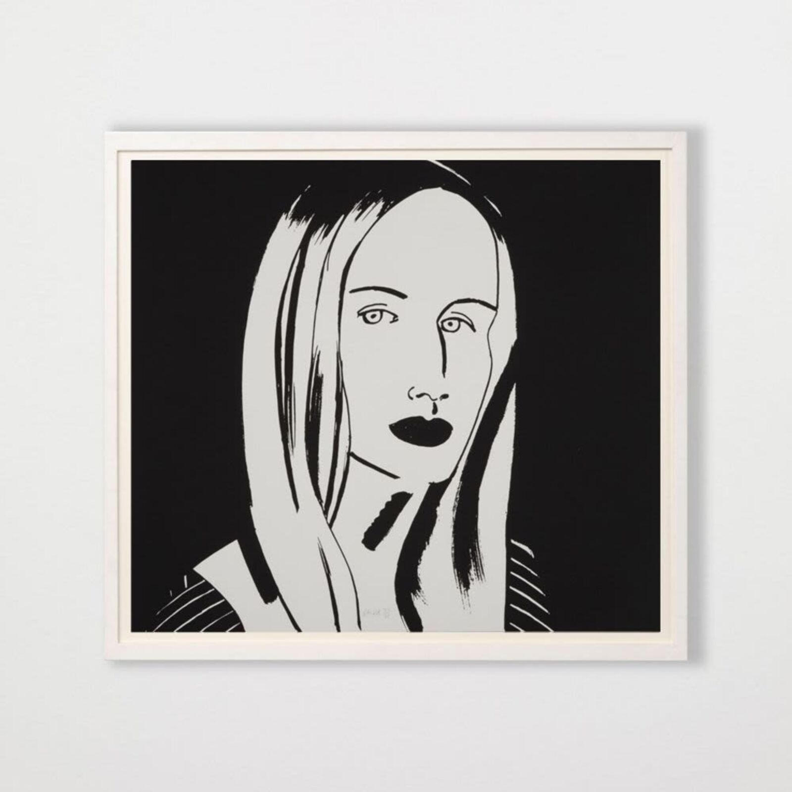 A black and white drawing of a woman's face on a wall.