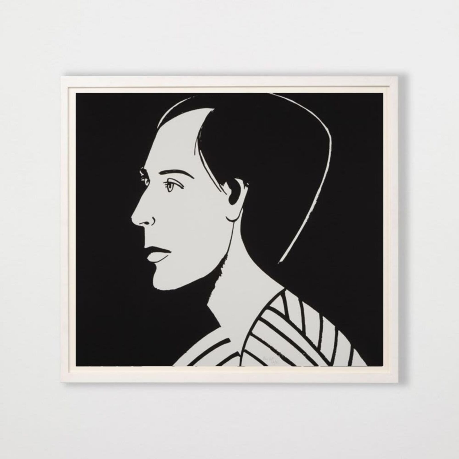 A black and white drawing of a woman's face on a wall.