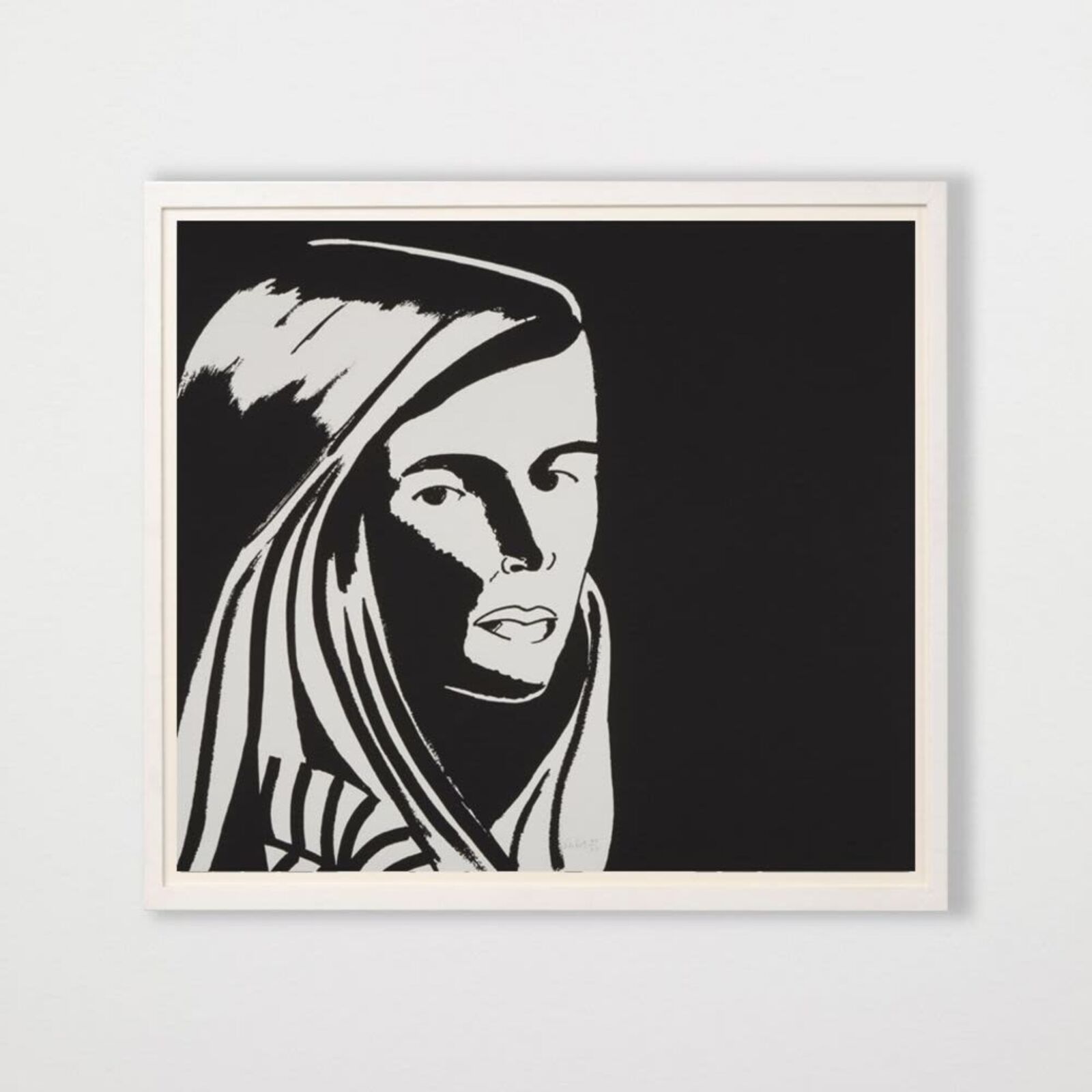 A black and white drawing of a woman's face on a wall.