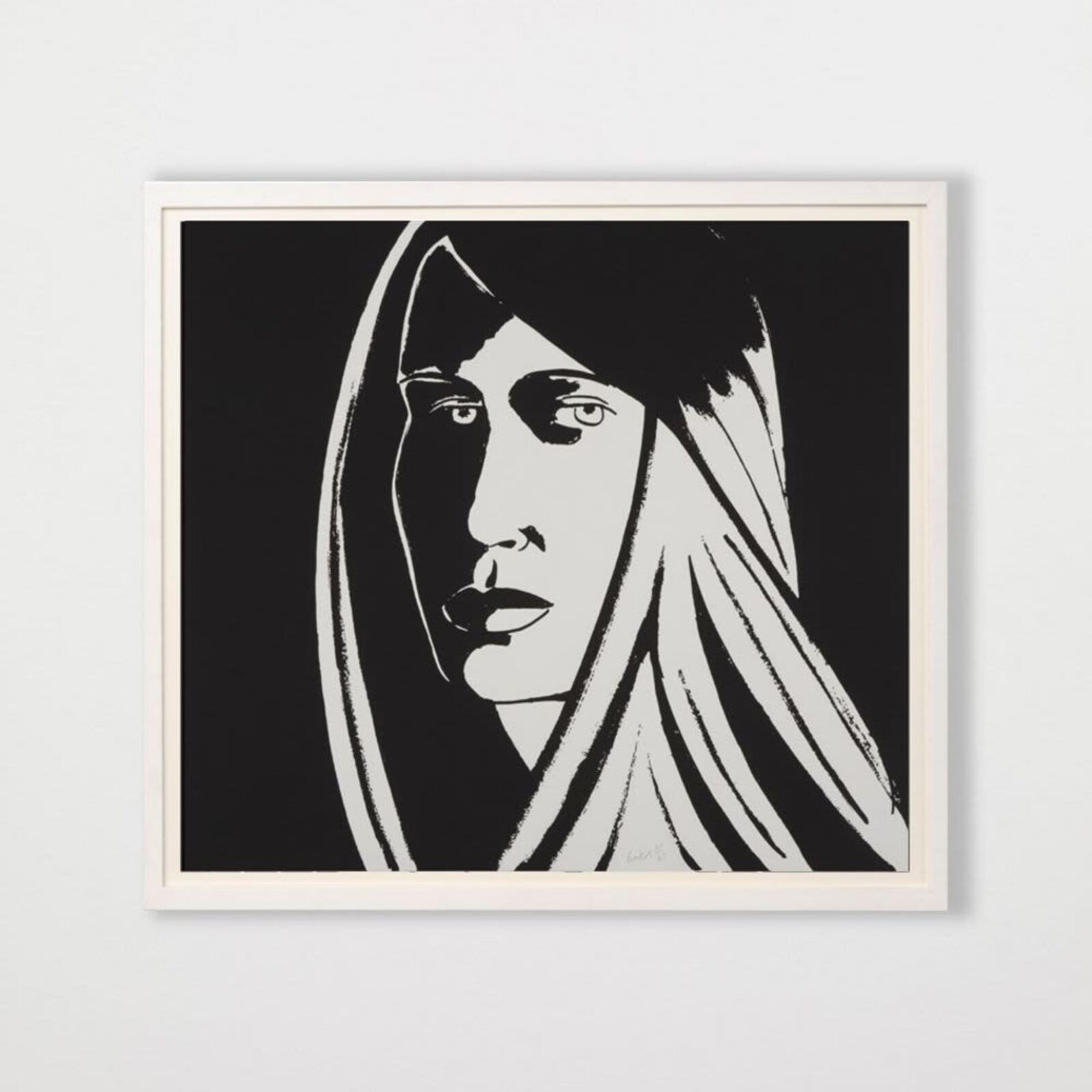 A black and white drawing of a woman's face on a wall.