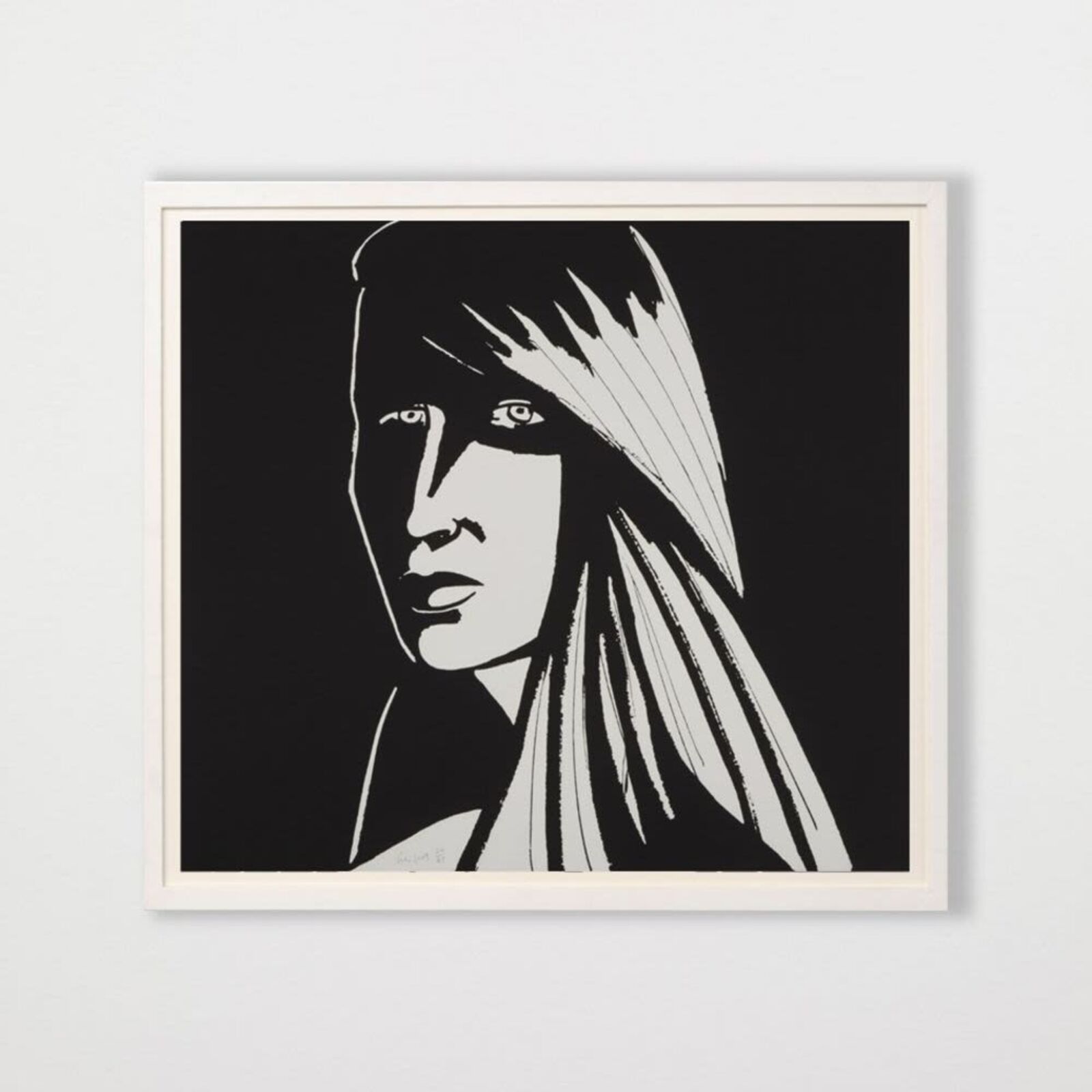 A black and white drawing of a woman's face on a wall.