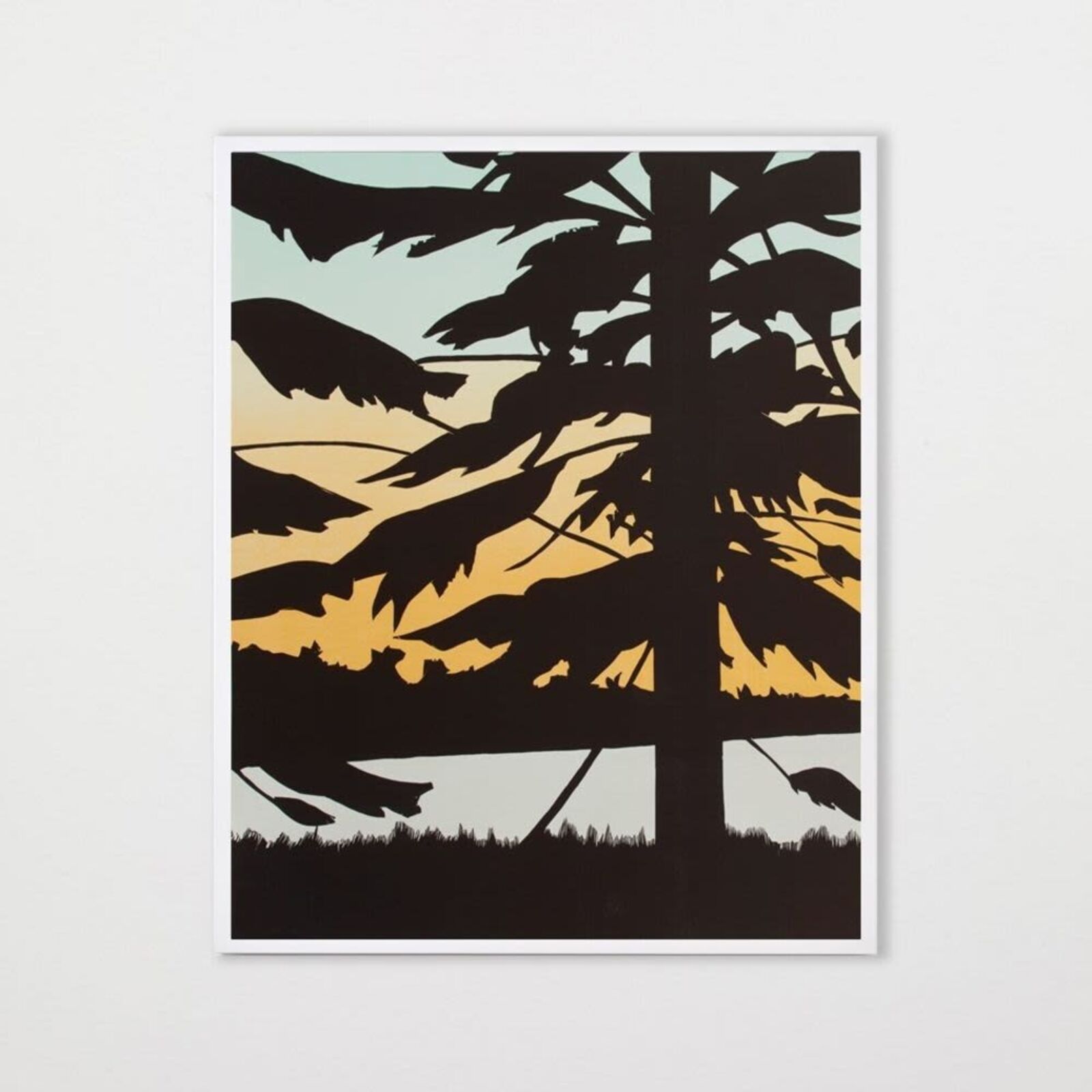 A set of three prints of a sunset with trees in the background.