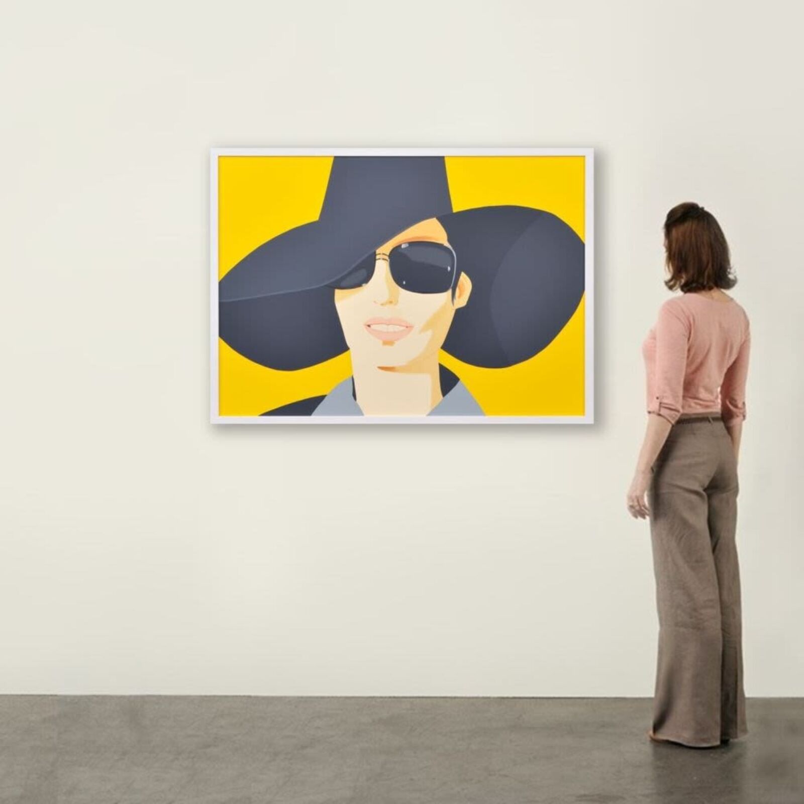 A woman wearing a black hat and sunglasses.