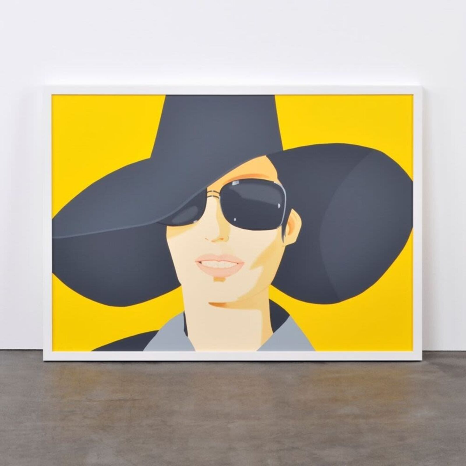 A woman wearing a black hat and sunglasses.