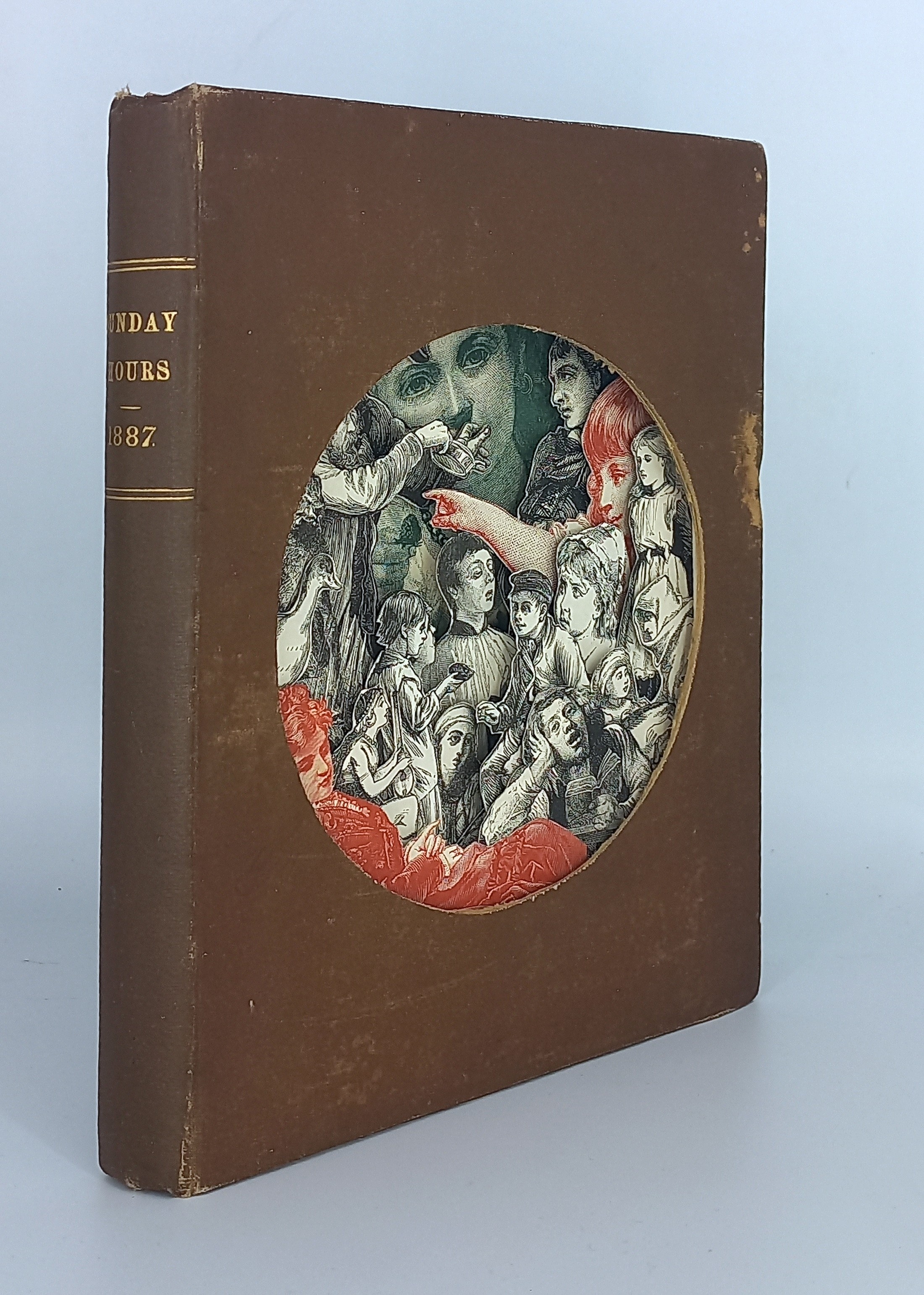 A brown book with a black pen on top of it.