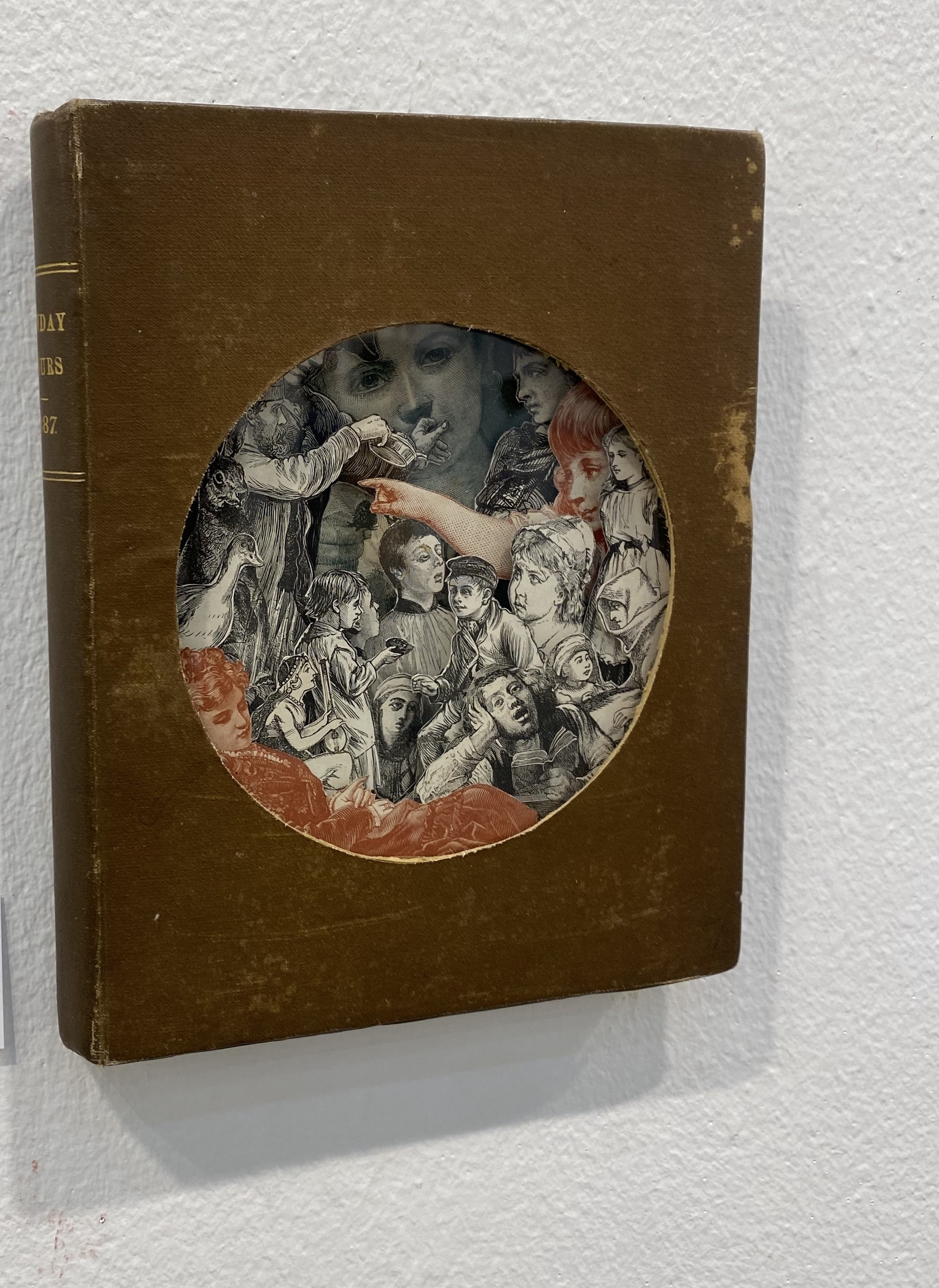 A brown book with a black pen on top of it.