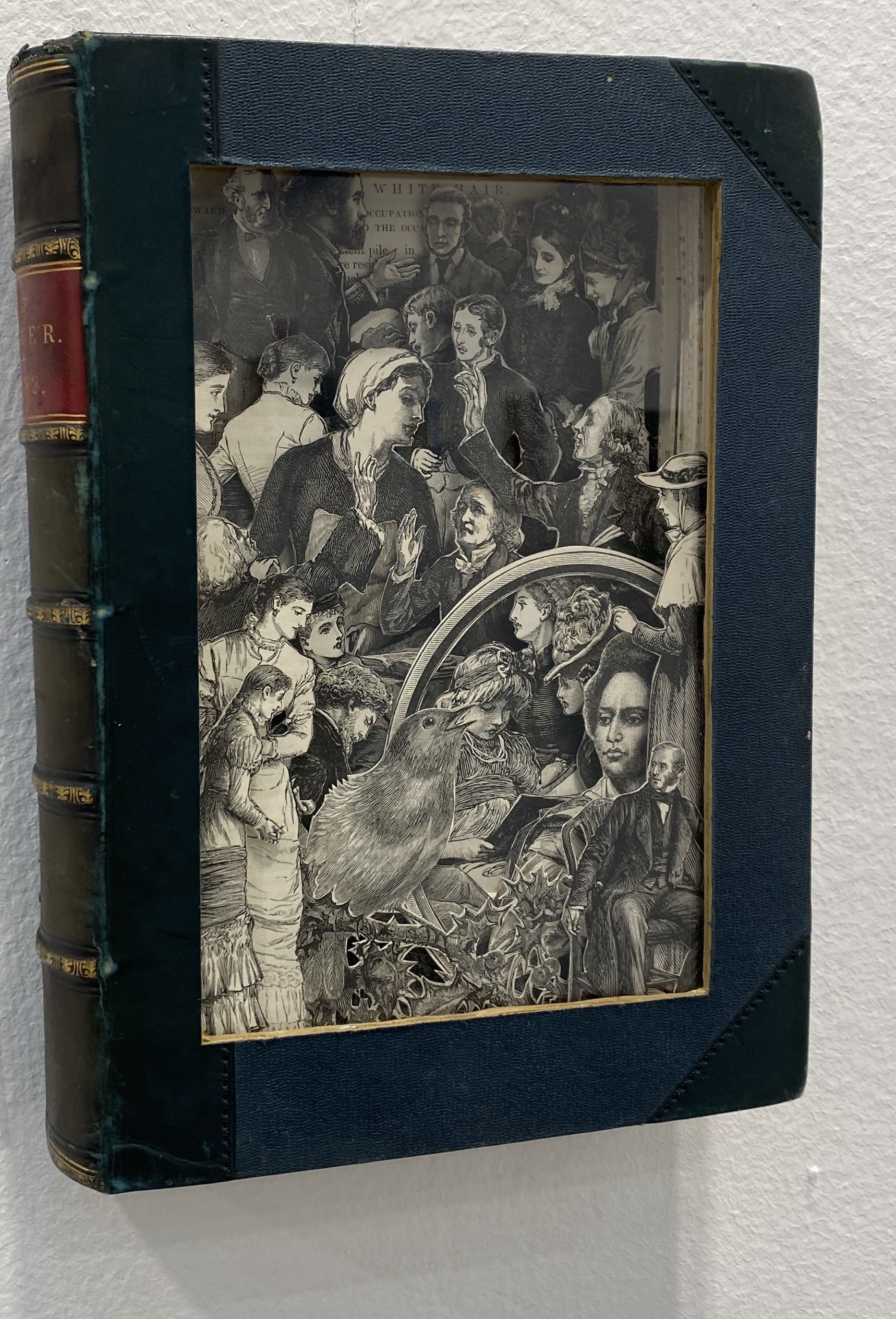 A book with a green cover sitting on top of a white surface.