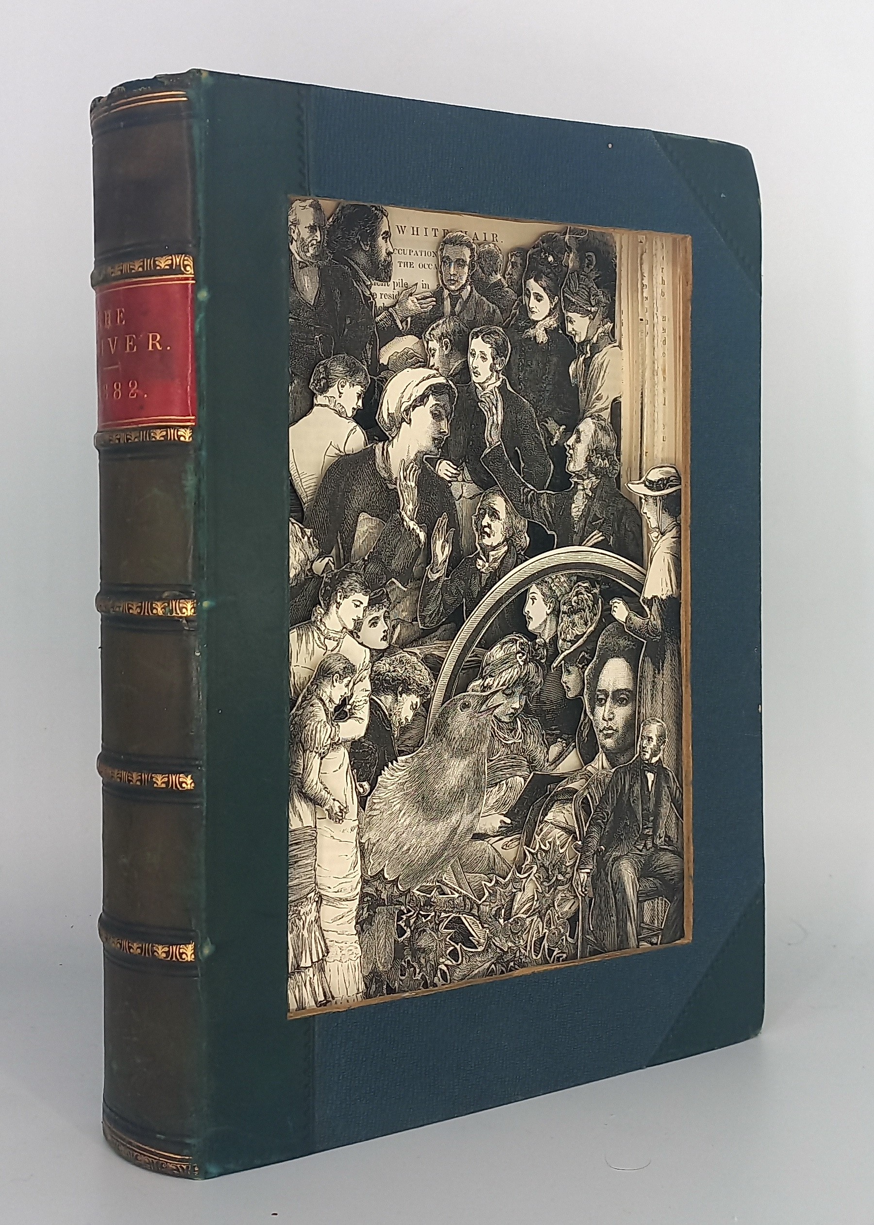 A book with a green cover sitting on top of a white surface.