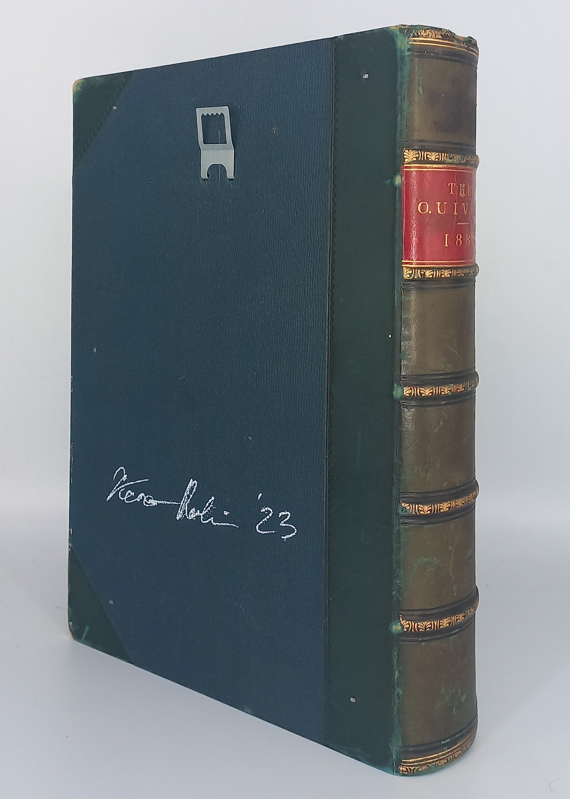 A book with a green cover sitting on top of a white surface.