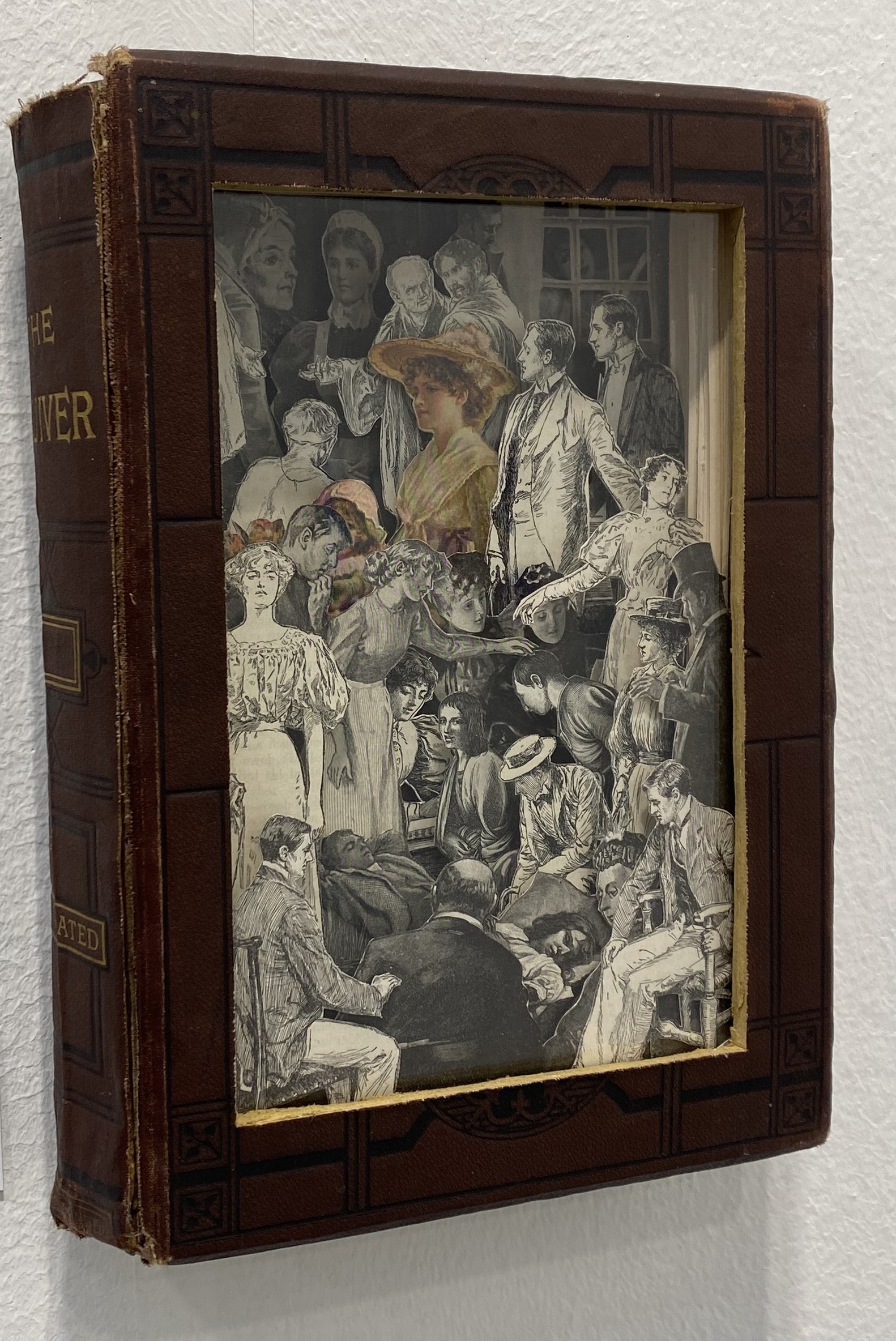 A brown book with a black and gold cover.