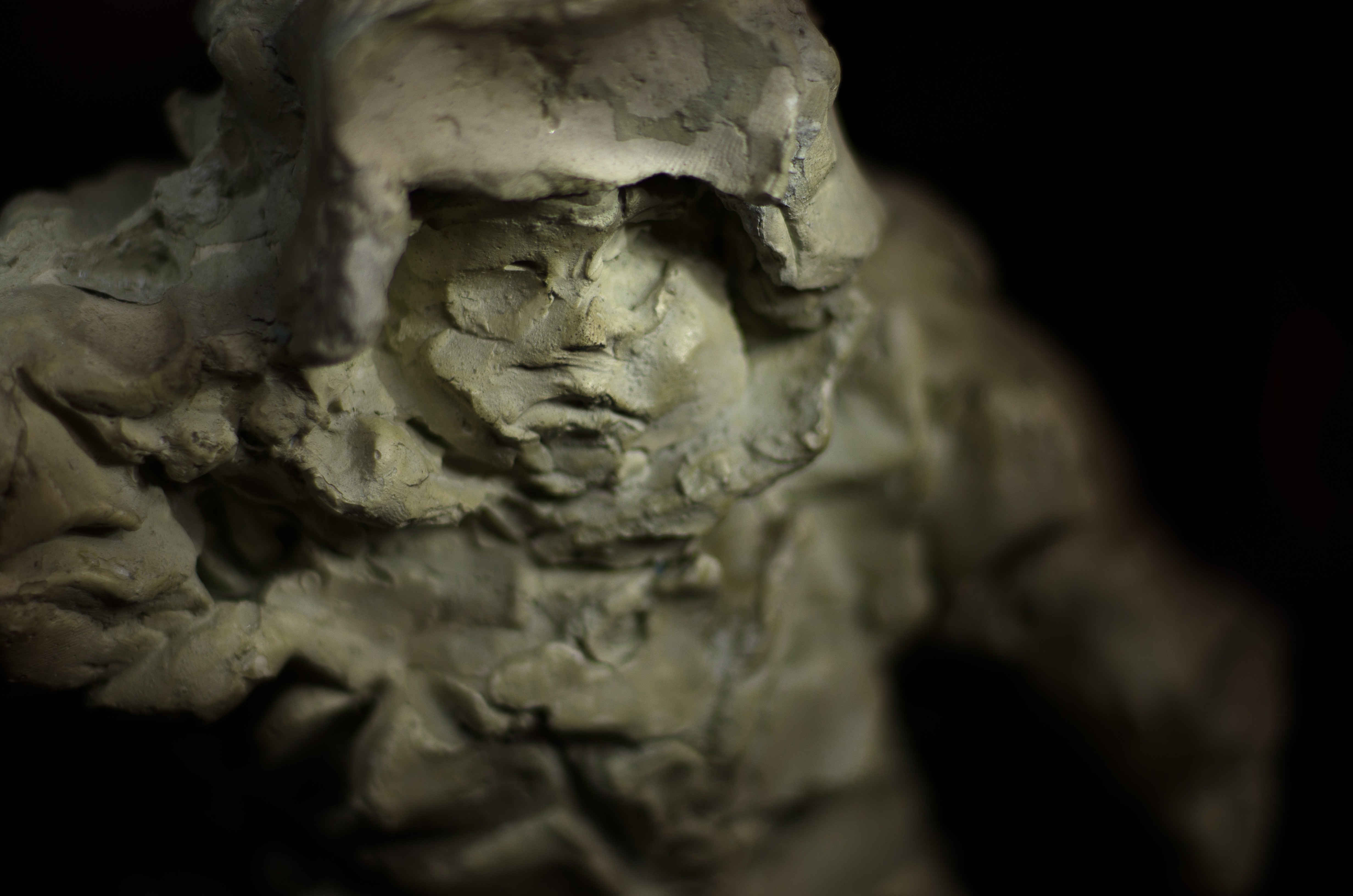 A sculpture of a man standing on top of a pedestal.