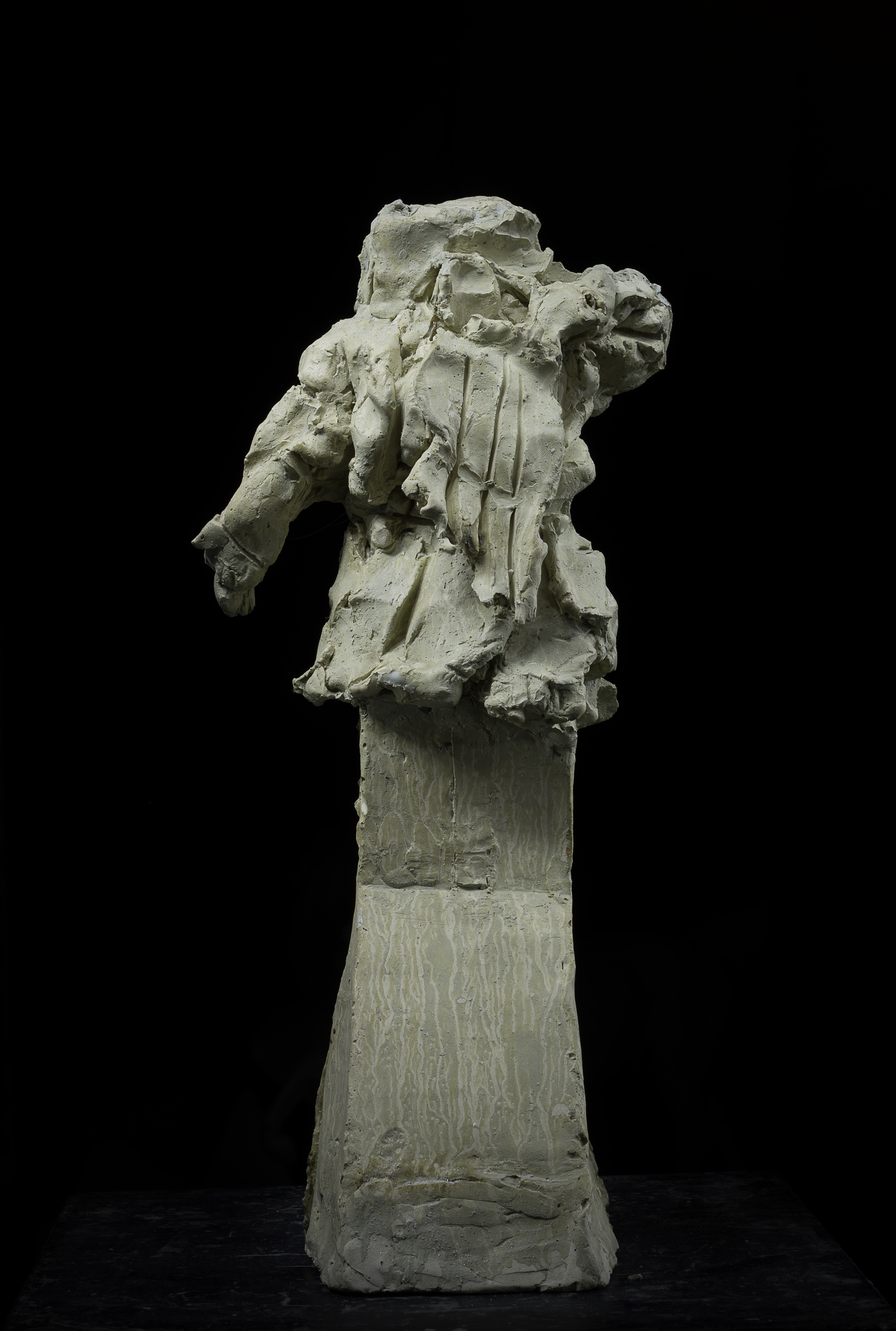 A sculpture of a man standing on top of a pedestal.