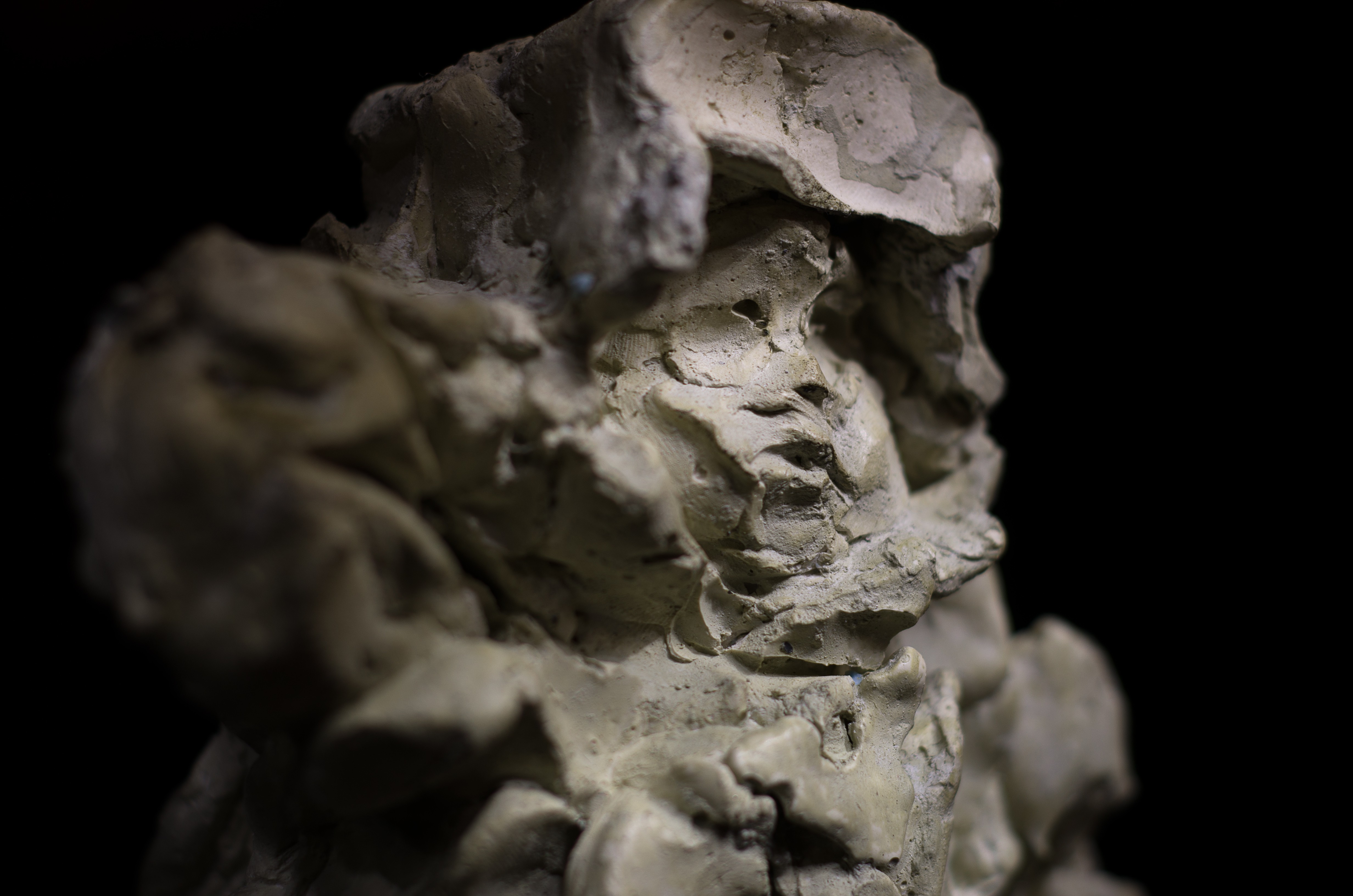 A sculpture of a man standing on top of a pedestal.