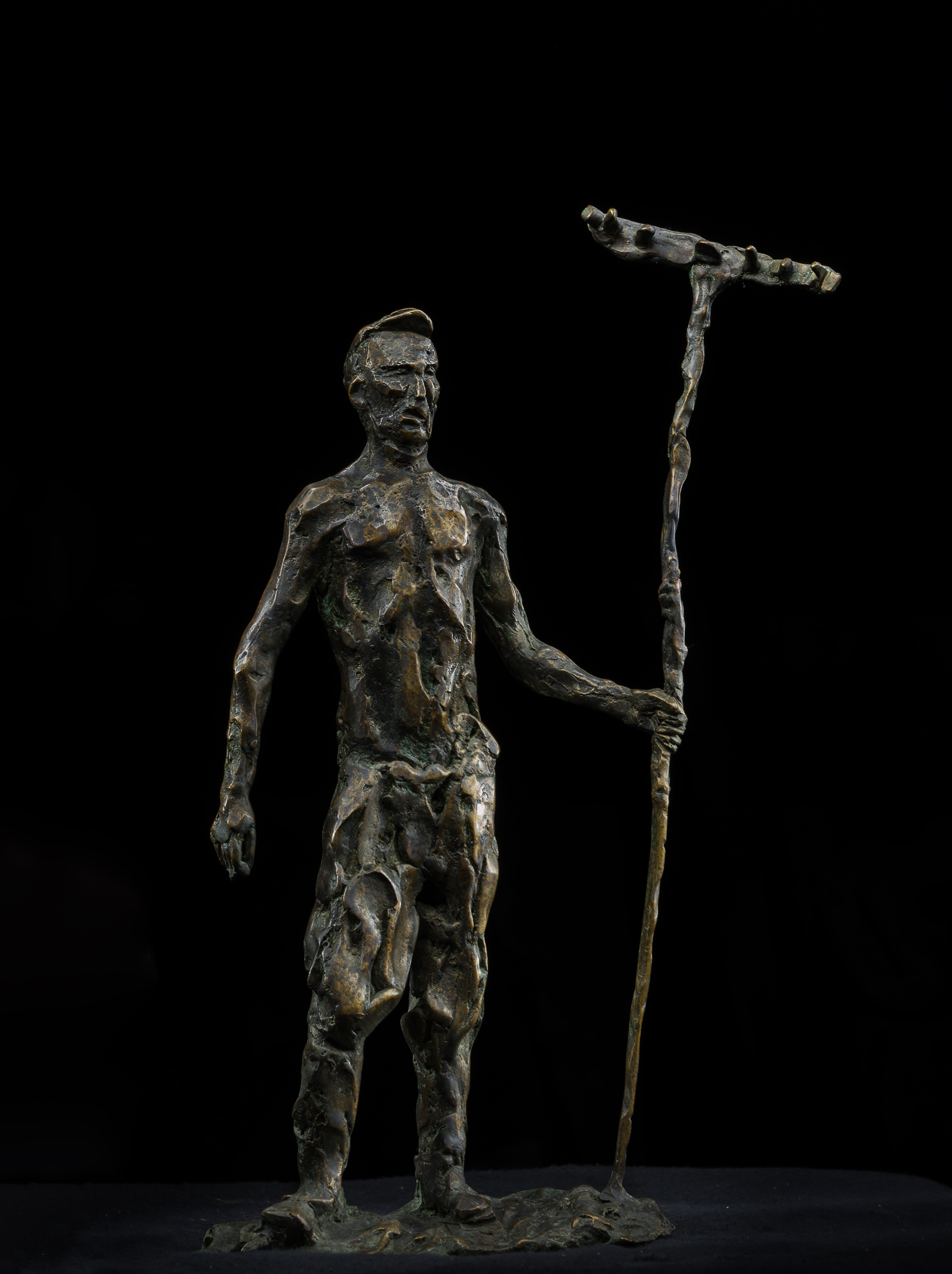 A bronze statue of a man holding a spear.