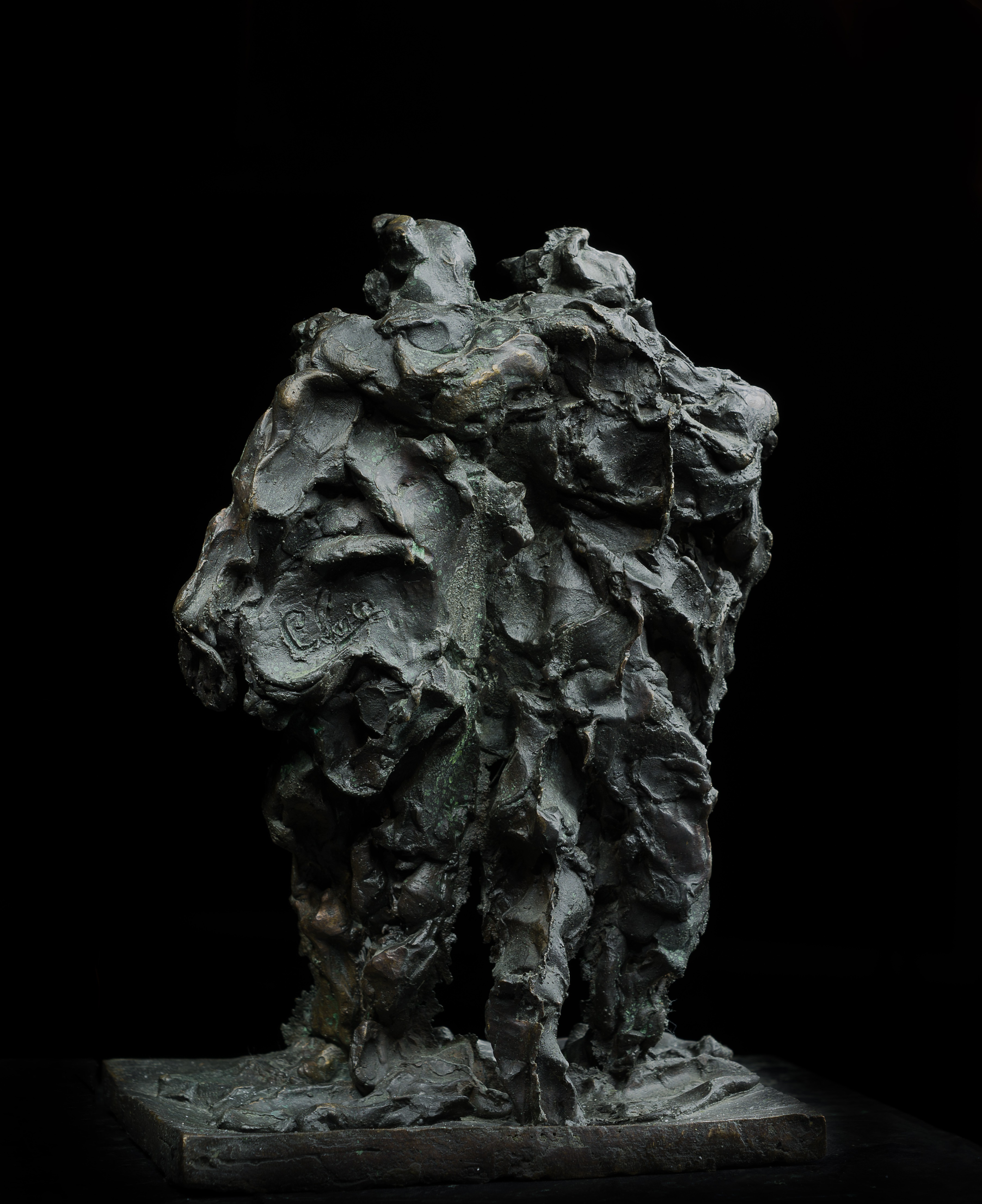 A bronze sculpture of two men standing next to each other.