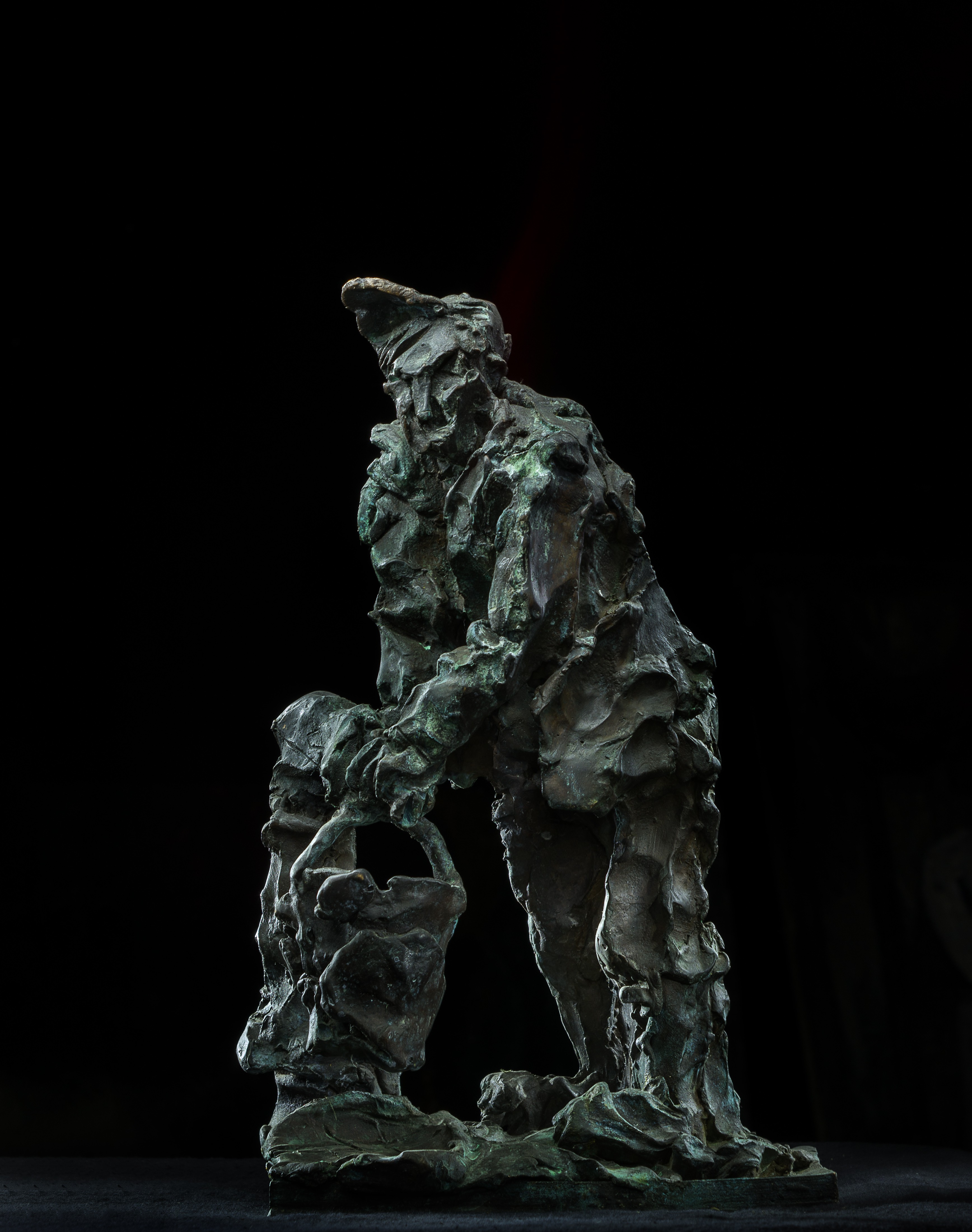 A bronze sculpture of a man holding a child.