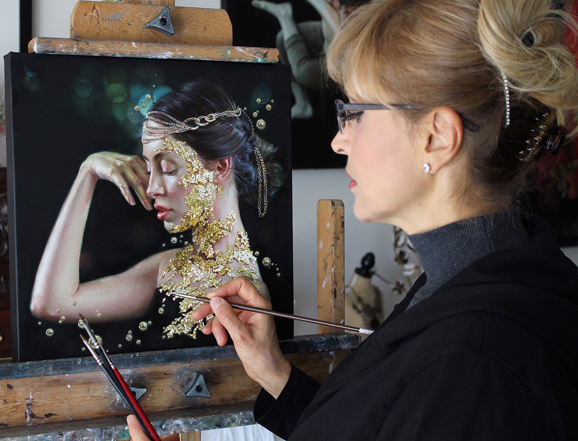 A painting of a woman with gold paint on her face.